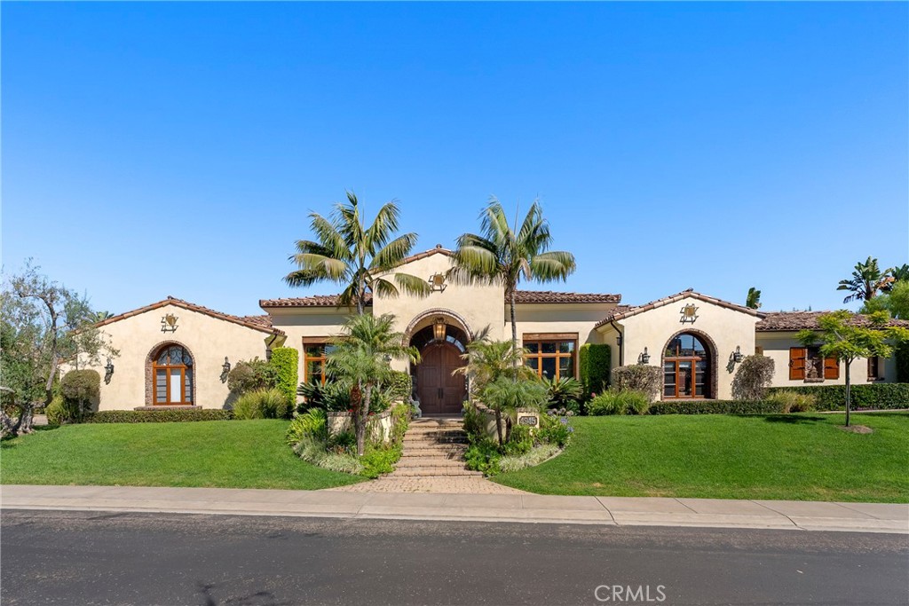 Gorgeous single level home in beautiful Rancho Pacifica. This beautifully maintained one story home is absolutely stunning. From the moment that you step into this home you will feel as though you are entering into a gorgeous Villa. The entryway is inviting and ornate with handcrafted designed iron and an ornate arched doorway. There is over $350,000 in woodwork in this pristine home that boasts high vaulted ceilings with skylights and handcrafted beams.
The woodwork is handcrafted in walnut and is gorgeous and robust and surrounds the home in an handcrafted, artisan ambience. As you enter into the home there is a spacious office that has custom walnut shelves. There is a welcoming formal dining room that has an ornate ceiling and iron chandelier. There is an expansive family room that has a grand fireplace and handcrafted shelves that are beaming with a high level of aesthetic harmony.
The room has immense glass sliding doors that open up to an alluring patio that has a fireplace, sink and refrigerator. It boasts a fantastic view of the gorgeous, sparkling beach style pool and jacuzzi that has a pebbled bottom and two overflowing waterfalls. There is also a media room with a theatre screen that comes down when your family is ready for that special movie night. There is a palatial primary bedroom that has a gorgeous fireplace, surround sound, high ceilings and coffee bar that leads into an expansive bathroom with a shower, sunken tub, bidet, and two expansive closets. This room has a view of the pool area and is enhanced with built-in handcrafted shelves. Down the hall is another generous-sized room with an ensuite full bath and walk-in closet. There are two other spacious bedrooms with ensuite bathrooms and showers. The kitchen has a large dining nook and a beautifully immense granite island with a separate sink, eating area with barstools, and warming drawer. Additionally, there are two dishwashers, a 72" inch SubZero with custom wood doors, wine cellar closet, roomy walk-in pantry, Viking Double Oven, Viking six burner cooktop, and trash compactor. There is a lofty laundry room down the hall and two separate car garages, one with three parking areas and one with two. There is immense space to house your cars. There is too much to mention and this home is a one-of-a-kind. A rare find single story on an enormous lot in a 24/7 guard secured neighborhood with top-rated schools and premier neighborhood.