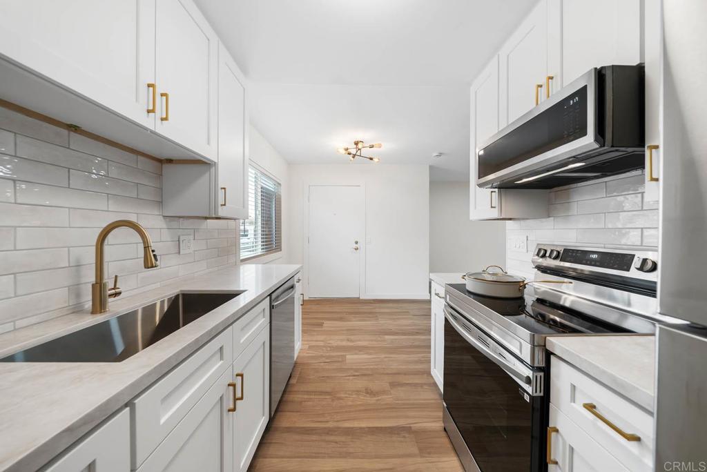 Stunning Fully Renovated Condo in City Heights! Welcome to this beautifully upgraded 2 bed, 1 bath ground-level unit in a gated complex in the heart of San Diego. This home features a completely remodeled kitchen with sleek quartz countertops, white shaker cabinets, subway tile backsplash, stainless steel appliances, and modern brass hardware. The spacious living room is flooded with natural light and showcases durable wood-look flooring that flows throughout the home. The stylishly remodeled bathroom boasts a tiled shower surround with built-in niche, dual-pane frosted windows for privacy, a modern vanity with marble top, and elegant gold fixtures. Additional upgrades include recessed lighting, dual-pane windows, and contemporary finishes throughout. This turn-key unit is perfect for first-time buyers or investors looking for low-maintenance living. Located just minutes from North Park, downtown, and freeway access — this one won’t last!