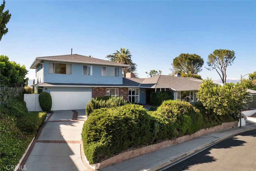 First time on the market in over 60 years! Pride of ownership shines throughout this six-bedroom pool home with breathtaking valley views perched on one of the most coveted streets in Woodland Hills. The main level features generous living spaces, including a primary suite, designed for effortless indoor-outdoor living. Upstairs, you'll find three additional bedrooms, an office, and a full bathroom. With its flexible layout, the second floor presents endless possibilities—create an ADU, mother-in-law suite, teen retreat, or an expansive primary suite with sweeping views. The backyard is an entertainer’s dream with a sparkling pool, putting green, a lower yard complete with a shuffleboard court, and stunning views. Nestled on a quiet street just minutes from world-class shopping, dining, The Village at Topanga, freeway access, and highly rated schools, this home perfectly blends serenity and convenience. With timeless charm, an unbeatable location, and exceptional potential, this property is ready to become a true showstopper.