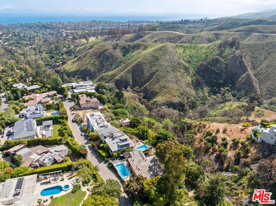 Set high in the Upper Riviera of Pacific Palisades, 1545 Umeo offers an extraordinary opportunity to build or finish a dream home with sweeping, unobstructed views from the rustic canyon to the Pacific Ocean. Currently in a fully gutted state, the property preserves its original mid-century footprint, elevated on stilts above the lush hillside for a dramatic architectural presence. The flat front yard includes an existing pool, while the surrounding landscape provides rare privacy and a breathtaking natural backdrop. Featuring 3 bedrooms and 2 bathrooms, this offering is perfect for developers or end users seeking location, potential, and unparalleled views.