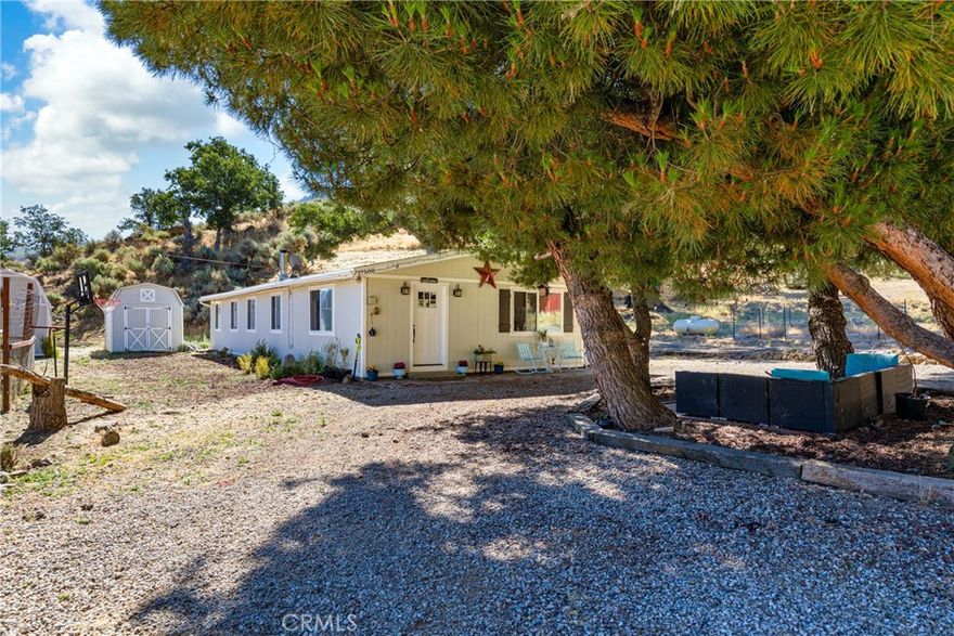 ***Welcome to this beautifully remodeled 3- bedroom, 2 bath home nestled on over an half-acre in scenic Stallion Springs, Surrounded by mature trees, (perfect for outdoor seating) and beautiful Scenic Mountain Views, this property provides a semi-rural lifestyle**This Well-Kept cozy and charming manufactured home has updated finishes and modern amenities- all situated on a spacious, usable lot in a peaceful mountain-adjacent community**Added outbuildings, carport, flexible outdoor space-including the chicken coop, enhance its country-living appeal**Walk-in to an open-concept living area, family room with a wood-burning stove, dining area and kitchen featuring butcher block and stainless steel appliances***Both bathrooms fully remodeled with new tile fixtures and plumbing: whole house refreshed, with fresh paint, flooring, windows and interior finishes**Whether you are looking for a peaceful full-time residence or mountain getaway, this home offers, charm, character and move-in ready comfort!