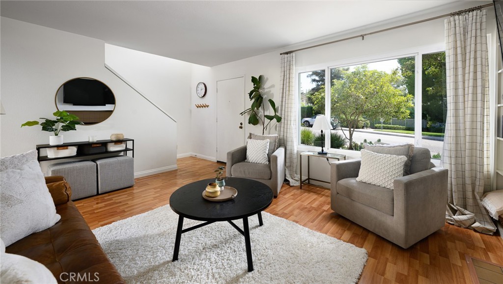 Step into this light-filled, end-unit townhome featuring 3 bedrooms and 1.5 bathrooms. Located in the desirable Villeurbanne community, this home offers privacy with no rear neighbors and only one shared wall. The interior boasts a spacious living room with a cozy fireplace, built-in shelving, and large windows. The bright, open kitchen has an adjacent dining area with sliding glass doors that open to a private rear patio, perfect for entertaining or quiet mornings. The primary retreat includes a large closet, dual vanities, and a makeup vanity. The townhome is equipped with an updated HVAC system (central air conditioning and heat), dual-pane windows, PEX plumbing, one carport parking space, and two assigned uncovered spaces. The resort-style community features a pool, spa, clubhouse, and hillside walking paths. It is just minutes from Orange Hill Restaurant, Old Town Orange, Peters Canyon & Irvine Regional Park, and offers easy access to the 55/22/91 freeways as well as the 241/261 toll roads—ideal for commuting!