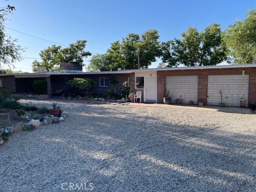 Charming unique ranch style block house, 3 bedrooms 1 & ¼ bathrooms. Owner has maintained/ updated the house while keeping the original charm of 1955. It’s a time capsule! Turnkey to live in or make it your own. New carpet in living room, hall, and bedrooms, newer blackout draperies throughout the house. Newer copper plumbing, new roof, New evaporative cooling. New Water heaters, quarter bathroom has been remodeled with new vanity and toilet. New laminate floors in kitchen and laundry room. Full bathroom is original and in great shape. The kitchen is also original and in good shape. 

This property is 24,000 SQFT with mature trees front & back of property. Nice island in the circle driveway. The RV access takes you to a back yard that’s a blank canvas! With decomposed granite, three out buildings, a block wall that separates the back into two sections. Could be used for, animals, storage, ADU or garden. The possibilities are endless!