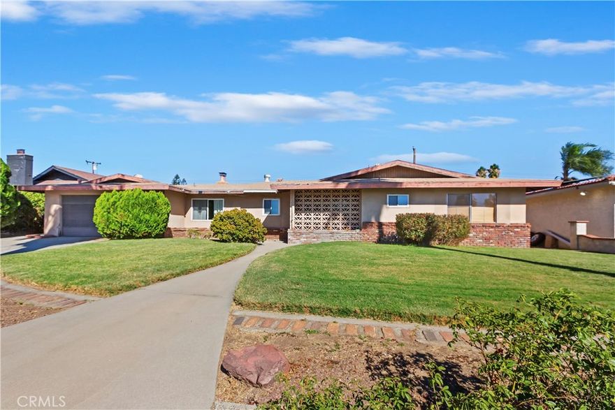 Premium location North of 210 Freeway in well established neighborhood.  Desirable single story ranch style home on an oversized 9600 sq ft lot.  Offering an updated kitchen with lots of cabinet and counter space, breakfast bar, dining area, spacious living room with cozy fireplace surrounded by rock hearth and facade, dual paned slider opening to back yard, wood laminate flooring in most rooms, large master bedroom with adjoining full bath, dual paned windows, mirrored storage closet in hallway as well as mirrored wardrobes in all bedrooms, and much more.  Spacious back yard with HUGE pool and spa.  Property has been a work in process that still needs some substantial work, but has tremendous potential and offers the right buyer an amazing opportunity to make it their own!