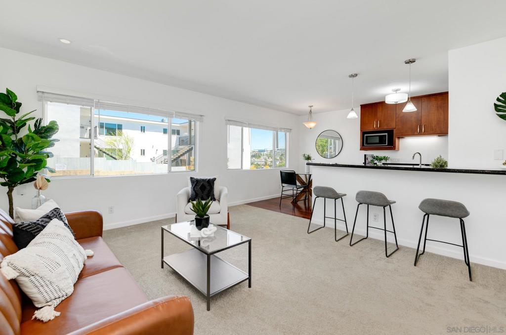 Beautiful one bedroom Hillcrest residence with easterly views. This well appointed floor plan is a perfect combination of location and value. As you enter the unit from the private courtyard, you’ll appreciate the brilliant hardwood flooring that leads to the “great-room” style open space area that joins the kitchen, dining & the living areas and look out to the Easterly neighborhood views. The kitchen features a gas range, stainless steel appliances, granite countertops, & pantry. Spacious private bedroom w/ newer flooring. Bathroom features a fully tiled tub & shower, tile flooring, & upgraded vanity/fixtures. In-Unit washer & dryer. Forced air furnace, and dedicated parking space right outside the unit. Enhancements include new flooring (carpet), custom blinds, and paint. Nothing to do but move right in! Located in the illustrious Bridgeview community, a quaint 28 unit building set atop the hill of North Park to the east and Hillcrest to the West, and gets its namesake from the iconic bridge that crests over University and Georgia street which is now listed on the National Register of Historic Places. Unit entry level is the same as entry into the complex (NO STAIRS TO UNIT). The community courtyard features a lounge area & tranquil fountain. Building amenities include a large pool, relaxation patio w/ adjacent BBQ area. HOA management is in good standing and offer relatively low HOA’s. The unit is light and bright & Turnkey. This property is exceptionally located to all that Hillcrest and North Park has to offer. Think of a cuisine and it’s minutes away. Walking distance to convenience, entertainment, cafés, grocery, restaurants, and shops. You’re at the doorstep of Balboa Park and downtown and just Minutes to the airport and easy freeway access. Call this amazing place your new home today!