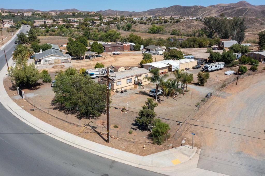Investor Special – Over 33,000 Sq Ft Corner Lot! Flat and usable 33,541 sq ft lot with existing 2 bed, 2 bath manufactured home + bonus room and workshop. Prime location near 15 Fwy, Hwy 74, Costco, Walmart & more. Perfect for new construction, ADU development, or land hold investment. Utilities on site. Endless potential
