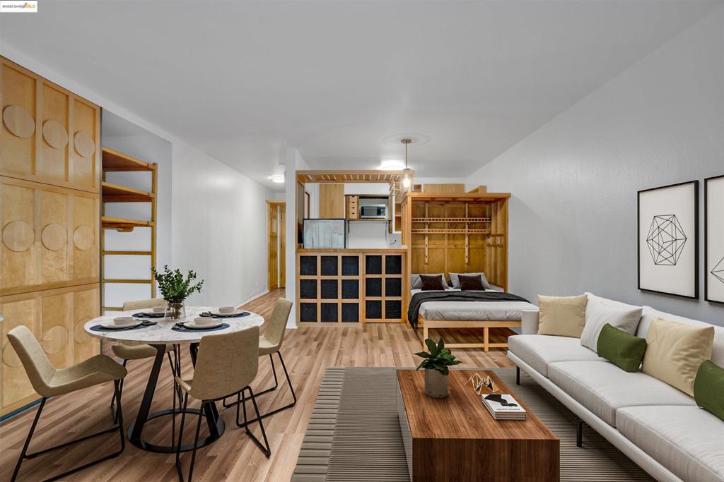 Welcome to 425 Orange St #210, a distinctive and thoughtfully crafted studio condo in the heart of Oakland’s Cedars complex. This 373 sq ft residence boasts a smart, space-efficient layout featuring a built-in Murphy bed frame, custom cabinetry, and warm wood paneling that adds character and comfort. Sunlight pours in through sliding glass doors, opening to your own private balcony nestled among lush greenery, the perfect retreat for morning coffee or evening relaxation. The kitchen features open shelving that enhances both style and functionality, while the bathroom is clean and well-appointed with tiled walls and custom corner shelving for added convenience. A spacious closet provides ample room for wardrobe and storage needs, which is a rare find in a studio layout. Located in a community with convenient laundry facilities, a sparkling pool, and assigned parking that includes EV charging and an additional private storage area. Just minutes from Whole Foods, Lake Merritt, BART, and the vibrant Uptown dining scene, this charming studio offers the best of Oakland living. With its prime location, it’s an ideal opportunity for first-time buyers, investors, or anyone seeking a stylish city retreat.