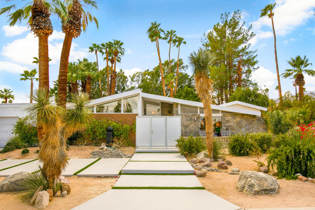 Experience The Holiday House - an iconic 1957 midcentury modern masterpiece, beautifully reimagined for modern living. Originally a model home for its builder, this architectural treasure has been lovingly updated to preserve its desert modernist charm while adding today's comforts. Set in one of South Palm Desert's most desirable neighborhoods, it's not only minutes from El Paseo's world-class shopping and dining, but also close to top-rated schools, parks, and community amenities.Situated on a lush 1/3 acre lot, this 3,350 sq. ft. home offers four bedrooms and four baths, including a private detached casita--ideal for visiting family and friends. The inside is full of charm and character with post-and-beam ceilings, clerestory windows, and walls of glass that invite natural light and garden views into every room. All bedrooms feature private outdoor access, creating a seamless indoor-outdoor lifestyle.The primary suite is a serene haven with a sitting area, and dual bathrooms--one with a luxurious soaking tub--plus a private patio. Two additional guest rooms each offer their own patios and plenty of space for comfort and privacy. The detached casita feels like a mini home of its own, complete with a bedroom, living area, kitchenette, dining nook, spa-like bath, and deck overlooking the backyard.Outdoors, it's resort-style living at its finest--swim in the sparkling pool, unwind in the spa, or enjoy shaded relaxation under mature trees. Host unforgettable gatherings with the fully equipped outdoor kitchen, fireplace, and multiple alfresco dining and lounging spaces.The Holiday House is the perfect blend of mid century architectural style, modern everyday comfort and quintessential desert lifestyle. Call to schedule a private showing today.