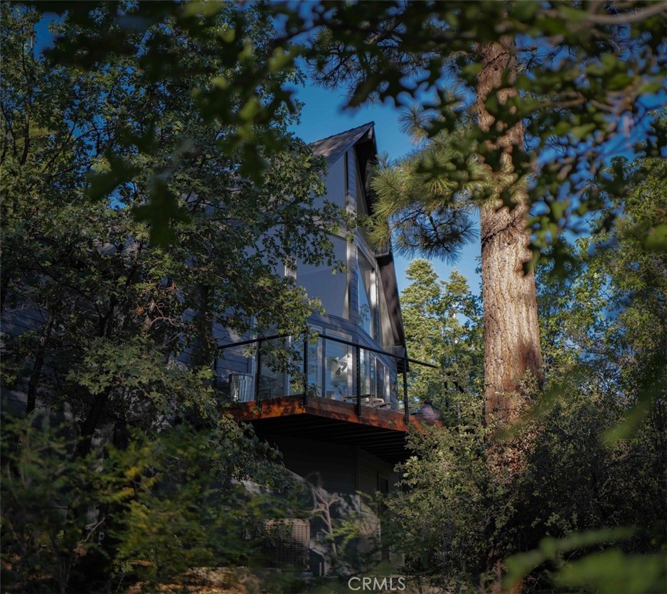 This beautifully loved home is perched in a cul-de-sac at the summit of Moonridge. It is the highest A Frame in the area, offering level entry w/ unmatched privacy & serenity. Originally built in 1970, the residence was completely reimagined in 2016 w/ a full interior renovation - the exterior following w/ a redesign just last year. The interior flaunts a chefs kitchen w/ Thermador appliances, & a Fisher Paykel refrigerator. Honed granite countertops w/ a butchers block that sits just proud. The primary bathroom boast a Kholer cast iron tub & Lefroy Brooks fixtures. The second bath’s center piece is an oversized shower w/ towering glass & a cast iron shower pan. The A Frame’s vertical space spans 28ft hight, w/ a floating iron staircase that leads you to the large loft - presently used as a screening area, it was originally an extra bedroom. A Haiku fan above the loft circulates the air creating a comfortable interior temperature year round. The heating & cooling was updated last year. The high efficiency variable speed York furnace is the quietest forced hot air available. York central air keep everything cool in the summer with a separate Daiken mini split which keeps things balanced in the loft area. All controlled remotely w/ a Nest thermostat & protected w/ nest fire alarm/CO2 detectors. The exterior was recently clad in James Hardie cement fiber siding. The roof was redone 2 years ago & fully wrapped in self adhesive underlayment creating a waterproof barrier. Then capped with efficient solar reflective Owens shingles. The three decks were also redone with South American Ipe & Viewrail rail systems. A deck level Hot Spring salt water hot tub, a Lumicast fire pit & an outdoor Ipe shower completes the exterior entertainment area just off the primary bedroom. An updated irrigation system keeps the roses, & newly planted trees well fed. Full spectrum Philips hue lighting brings the landscape to life, & helps create any mood you desire inside & outside the home.