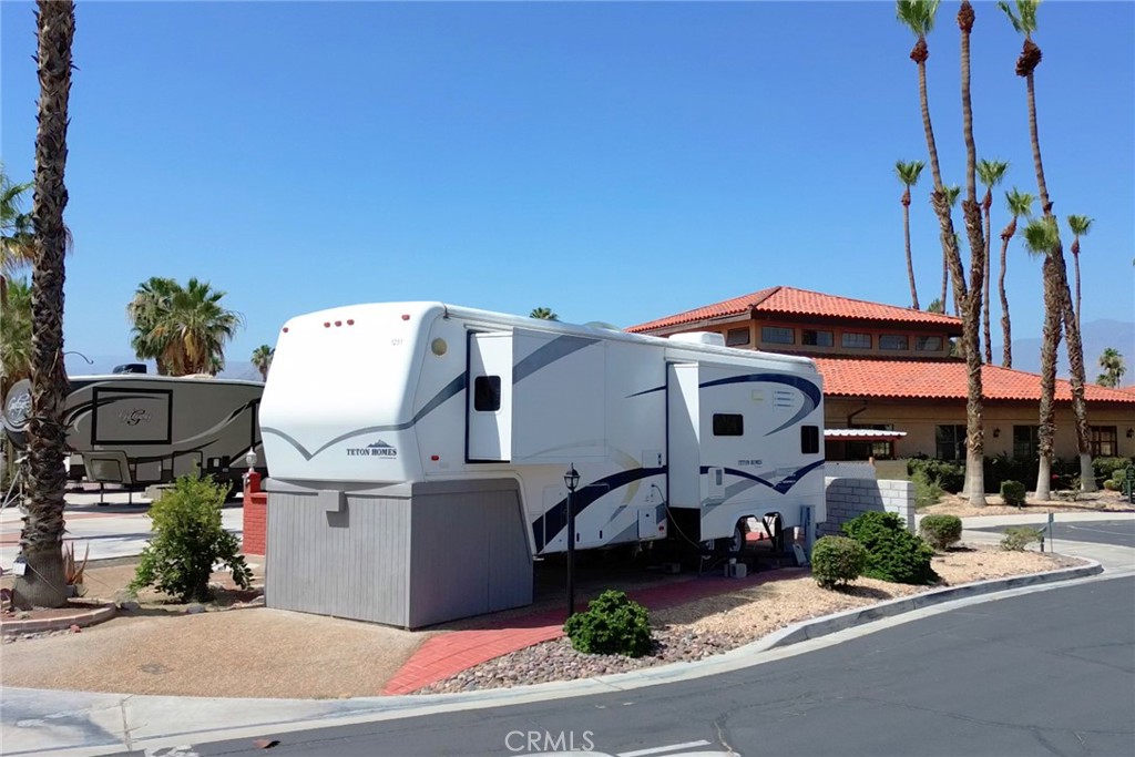 LOCATION! Steps to indoor pool! lap pool! pickle-ball, tennis, Listed Here is the Complete Package of Grant Deed Land in Desert Shadows RV Resort Packaged with this luxurious Teton Homes manufactured high-end, luxury fifth-wheel! Known for their spaciousness, abundant storage, and residential-style features. They were designed for full-time RV living and incorporated features like large exterior storage compartments (a patented Teton design), high-end kitchen appliances, and professionally decorated interiors. Desert Shadows RV Resort offers 2 large & well-maintained clubhouses plus 3 additional satellite clubhouses, An indoor pool with a large spa and sauna, An olympic-size lap pool, A total of 6 pools, 5 spas and 3 saunas, Sunken, lighted tennis courts, 8 Pickle-ball courts, An indoor shuffleboard pavilion, 16,000-square foot San Jacinto room with floating hardwood dance floor, and a professional stage, plus a large kitchen, A 3,000-square foot “Our Gang” party room and lounge with a giant fireplace and kitchen, A huge party terrace with mountain views, A fully equipped fitness center, A dance studio, Library, Billiards room, Horseshoe pits, Several laundries, restrooms and bath facilities, Card & hobby rooms with Pottery Kiln, A putting green, Organized fitness activities, Daily activities including dances, dinners and entertainment, Wi-Fi and wired broadband Internet access. Close to everything! The Best Kept Secret in Coachella Valley! Must See this Resort! Luxurious Park Trailer available as a package! You Own Land! Grant Deed Lot with Water, Cable, Trash, and common area included in HOA!
Lot can be sold without 5th wheel for 75,000