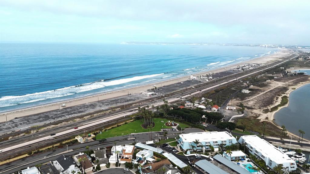 Located in the highly desirable Jamaica Village community of Coronado Cays, this beautifully maintained 2-bedroom, 2.5-bath home offers the perfect blend of California indoor-outdoor living and resort-style amenities. Just a short walk to the beach, this home showcases 180-degree panoramic ocean views, including spectacular sunsets over Point Loma and the Coronado Islands. Inside, you’ll find two spacious primary suites—each with its own en suite bath—plus a family room, den, and sunroom filled with natural light. The upstairs retreat and private deck provide the ideal vantage point for evening sunsets, while upgraded spaces embrace seamless indoor-outdoor flow. Step outside to lush landscaping and a private backyard designed for entertaining, complete with inviting deck spaces to enjoy cool coastal breezes. The attached 2-car garage offers convenience and storage. As a resident of Jamaica Village, you’ll enjoy access to a private beach, swimming pool, and clubhouse with BBQ—perfect for gatherings and relaxing weekends. Blending comfort, style, and coastal charm, this Coronado Cays home embodies the best of San Diego beachside living. Located in the highly desirable Jamaica Village community of Coronado Cays, this beautifully maintained 2-bedroom, 2.5-bath home offers the perfect blend of California indoor-outdoor living and resort-style amenities. Just a short walk to the beach, this home showcases 180-degree panoramic ocean views, including spectacular sunsets over Point Loma and the Coronado Islands. Inside, you’ll find two spacious primary suites—each with its own en suite bath—plus a family room, den, and sunroom filled with natural light. The upstairs retreat and private deck provide the ideal vantage point for evening sunsets, while upgraded spaces embrace seamless indoor-outdoor flow. Step outside to lush landscaping and a private backyard designed for entertaining, complete with inviting deck spaces to enjoy cool coastal breezes. The attached 2-car garage offers convenience and storage. As a resident of Jamaica Village, you’ll enjoy access to a private beach, swimming pool, and clubhouse with BBQ—perfect for gatherings and relaxing weekends. Blending comfort, style, and coastal charm, this Coronado Cays home embodies the best of San Diego beachside living.