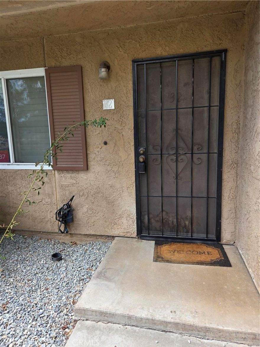 Huge Price Reduction!!!   Welcome all first-time home buyers and Investors! If you are looking for a starter Condo, then this is the place!  This property features a spacious living area featuring a living room, with Plantation shutters, with newly vinyl flooring in both the living and dining areas, separate dining area, located next to the kitchen, one bath downstairs with an indoor laundry area located within the bathroom for your convenience.  Two good size bedrooms, both located upstairs. A large balcony is located off the Primary bedroom.  A full partially renovated bathroom.  One of the bedrooms has not one, but two closets, one being a walk-in closet.  Carpet throughout the upstairs. There is a carport, with two parking spaces and two storage units.  The HOA covers trash, water and groundskeeping. Located near Freeway and shopping areas.   Don't miss this opportunity!