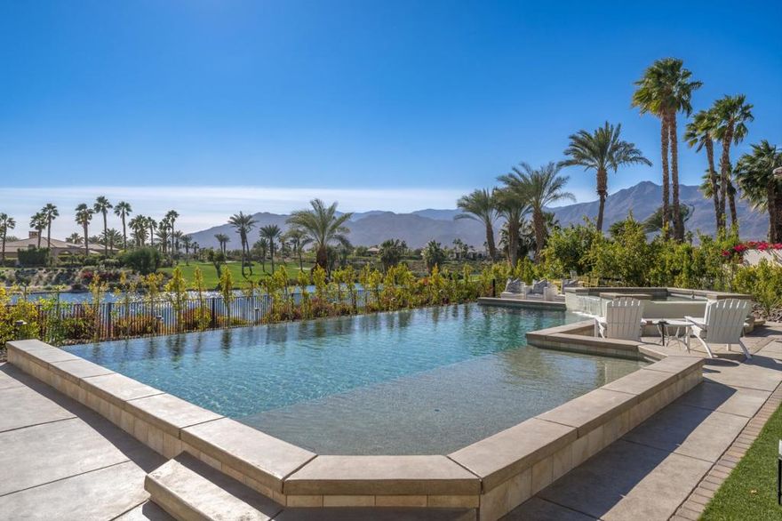 This upscale residence combines classic elegance, warmth, and luxurious finishes with the highest quality construction. Nestled in one of the most coveted locations in Andalusia Country Club, this home sits on a private single-loaded cul-de-sac street, offering breathtaking South-facing views of the mountains, a serene lake, and the 4th green. Spanning 5,116 square feet, this 4-bedroom home includes an attached casita that serves as the perfect retreat. Complete with a bedroom, bathroom, kitchenette, and living room that can double as a 5th bedroom, it offers comfort and privacy for guests. The open floor plan is highlighted by a soothing designer color palette, updated finishes, and thoughtfully designed spaces, including a secluded office that looks out onto a private courtyard with a peaceful fountain and lush landscaping. The updated kitchen is a chef's dream, featuring Wolf, Sub-Zero, and Miele appliances. Luxurious rooms flow effortlessly throughout the home, from the inviting living spaces to the tranquil bedrooms. The backyard is a true oasis, showcasing an infinity-edge saltwater pool with a spa and waterfall feature. Relax on the shelf, step under an umbrella or entertain while enjoying the picturesque surroundings. The beautifully landscaped grounds include citrus trees and mature greenery. Every detail has been carefully curated to ensure comfort and style. This home is the epitome of light, bright & spectacular living--don't miss this extraordinary opportunity!