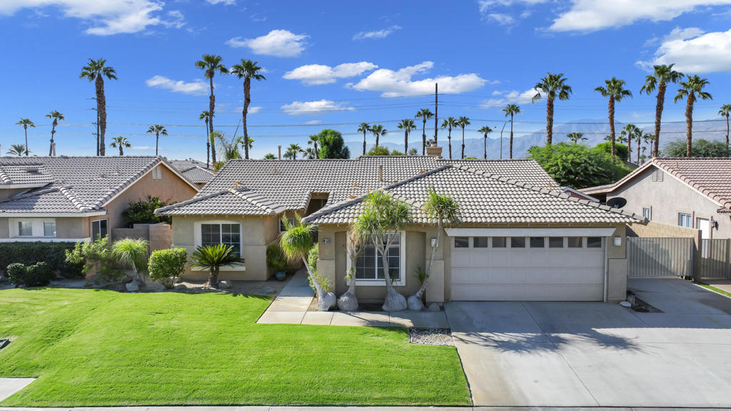 Sold turnkey and ready to enjoy! This south-facing home offers unobstructed Santa Rosa Mountain views and a prime central location in west Indio, right on the La Quinta border. Easy access to the freeway, Hwy 111, and Fred Waring puts the entire valley within minutes. Inside, you'll find an open kitchen with a large quartz island, abundant cabinetry, and a gas stove. The spacious primary suite opens directly to the backyard, with a bathroom featuring a double vanity. Highlights include a stunning stonework fireplace, tankless water heater, water softener, and included storage shed. The backyard is expansive and private despite its convenient location--perfect for soaking in those breathtaking mountain views. Walking distance to coffee shops and grocery stores.