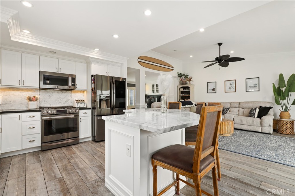 Experience the best of coastal California living in this beautifully updated condo nestled in the desirable Faire Harbour community of Marblehead. Showcasing ocean, sunset, and treetop views, this light-filled home offers stylish upgrades, thoughtful design, and a location that brings the beach lifestyle to your doorstep. Originally built as a 3-bedroom, this open-concept home now features two spacious bedrooms and a versatile open office space that can easily be converted back into a third bedroom. The upgraded kitchen is a showstopper—highlighted by a large marble island, black stainless-steel appliances, and soft-close cabinetry. Vaulted ceilings, dual-pane windows, plantation shutters, and wood grain ceramic plank flooring enhance the natural light and airy feel throughout the home. Retreat to the primary suite, where you’ll enjoy a private balcony, cedar-lined walk-in closet, and a spa-inspired ensuite with a custom steam shower featuring six showerheads. The second bedroom also includes a walk-in closet, and the hall bathroom has also been tastefully remodeled. Modern lighting, ceiling fans, recessed lights, and dimmers complete the polished interior. Outside, the main balcony offers panoramic views and ample space to relax by a fire pit, along with a private laundry closet with washer and dryer hookups. Just steps below the entry, the detached two-car garage provides convenient access at the base of the entry stairway. Faire Harbour HOA offers a resort-like atmosphere with a pool, spa, sand volleyball courts, and a clubhouse—all within beautifully landscaped grounds and ocean-close breezes. This quiet, well-kept neighborhood is ideally located near beaches, Sea Summit hiking trails, award-winning schools, the Outlets at San Clemente, and dining options. Whether you’re relaxing at home or heading out for a coastal adventure, this is the perfect place to call home. Don’t miss this opportunity to own such a charming and well-appointed ocean-view condo in San Clemente!