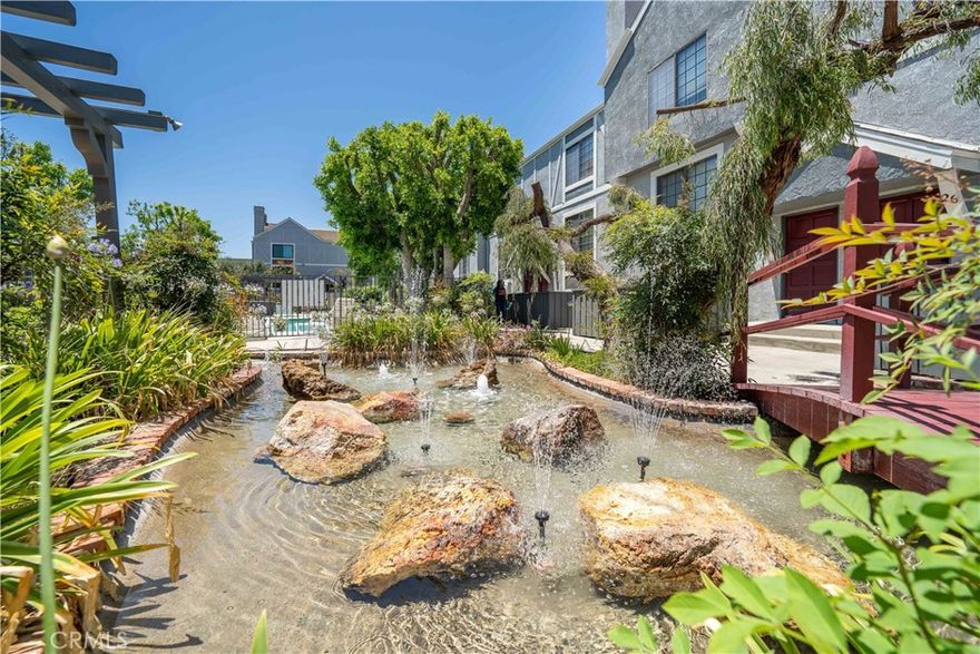 Welcome home to 18100 Burbank Blvd #11, a spacious, updated, and move-in–ready residence located in the desirable Lindley Townhomes community. Offering one of the lowest prices per square foot among active listings in Tarzana, this tri-level townhome delivers exceptional value with approximately 2,112 sq ft of living space, 3 bedrooms, 4 bathrooms, and an attached 2-car garage. HOA dues conveniently include water, internet, TV, and trash.
The entry level features a bright living room with a cozy fireplace, high ceilings, and abundant natural light. A formal dining area flows seamlessly into the updated kitchen, which includes generous counter space, a breakfast nook, and an additional casual living/dining area perfect for entertaining.
Upstairs, the primary suite includes its own fireplace, three closets, and a spacious en-suite bathroom with dual sinks. A second upstairs bedroom also offers an en-suite bath, ideal for privacy. The lower level offers a third bedroom with its own bathroom, direct garage access, and the laundry area.
Outside the front door is a charming patio space, while the gated community offers peaceful ponds, picnic areas, and a sparkling pool. This light-filled home is priced to sell and offers impressive square footage and amenities in a prime Tarzana location. Photos are presented in their current form.