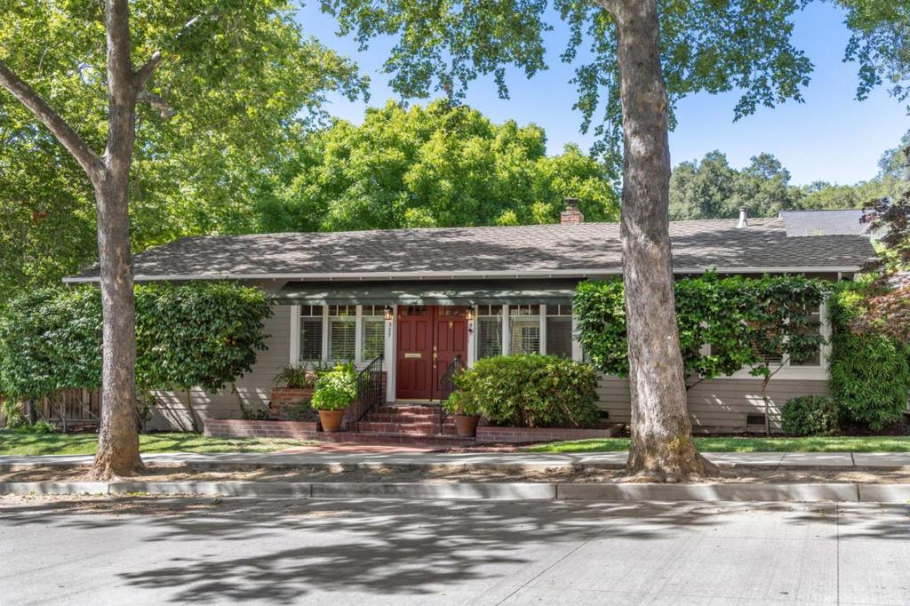 Experience the charm of Downtown Los Gatos with an elegant, single level home and extensive storybook garden located in the heart of the highly-desirable Almond Grove District. Magnificent, updated and well-kept living space with gorgeous, solid hardwood floors throughout, high ceilings, extensive framed windows and skylights, fireplace, plantation shutters, handsome built-ins and stately French doors that lead onto 2 walk-out decks and garden with pergola, stone patio and paver walkways, 2 lawns, potting bench with sink and fountains - a tranquil and private space. Large, light-drenched kitchen with extensive cabinet space, gas range, pantry and spectacular over-the-sink window offering both backyard and wonderful hill views. Nicely appointed bathrooms with updated and spa-like multi-head shower enclosure and soaking tub under a large skylight. Bonus reading room - great as a study, hobby room or large walk-in closet. Indoor laundry closet with modern appliances. Glorious dogwood, Japanese maples, sycamores and other mature plant life. Spacious 2-car garage. Large driveway with pavers. Just one block to beautiful Bachman Park. Top-rated Los Gatos schools.