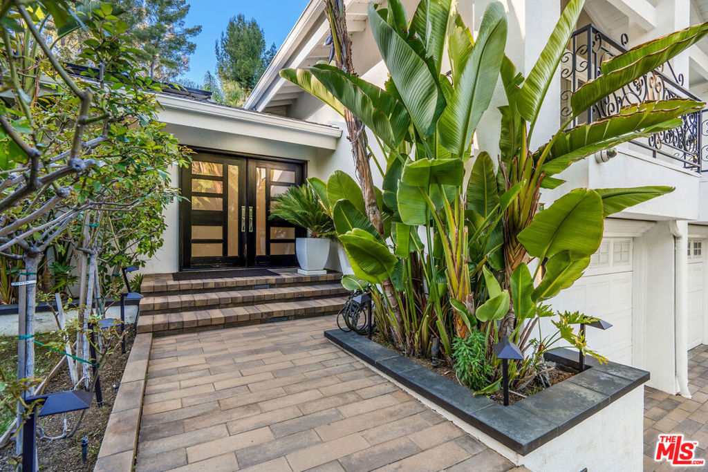 Welcome to this beautifully remodeled gem located south of the Boulevard in Tarzana. From the moment you arrive, you'll be drawn in by the stunning curb appeal, lush landscaping, and soaring palm trees that frame the entrance. Inside this spacious home offers 4 bedrooms and 4 bathrooms, with an open-concept layout designed for both everyday living and entertaining. The gourmet kitchen features top-of-the-line appliances, a massive center island, and a farmhouse sink with views of the covered patio and backyard. Downstairs, you'll find a second family room complete with a built-in bar, a stylish powder room, and a converted garage offering a kitchenette, custom cabinetry, a separate bedroom, and a dedicated laundry room, ideal for guests or extended family. Upstairs, the oversized primary suite boasts a private balcony and is accompanied by two additional bedrooms. With multiple living areas, a resort like pool, and all the upgrades throughout, this is a home you don't want to miss. This is a true entertainer's home and move-in ready. This home is equipped with low energy solar panels, just imagine how much you will save each month on your electricity bills. Come see it before it's gone! Property is also being offered partially furnished.