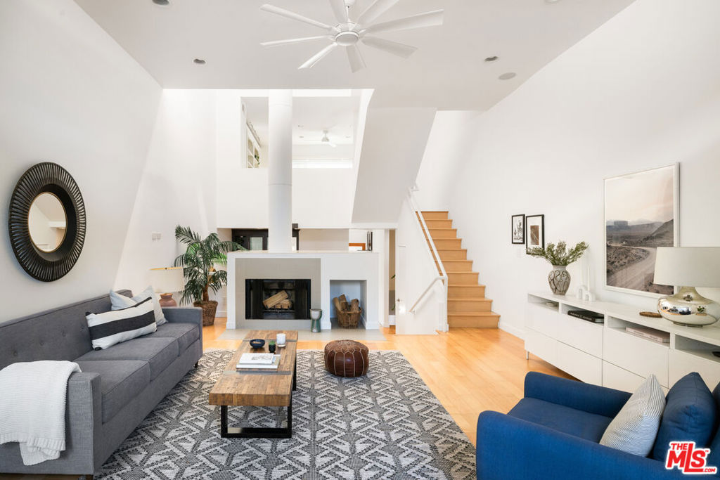 Nestled on a tree-lined street in a tranquil pocket of Sunset Park, this beautifully designed architectural townhome offers California living at its best. Step inside to find soaring ceilings and an abundance of windows and skylights that create a true sense of openness and light. The vibrant multi-level home offers 2 spacious bedrooms plus a versatile loft space that can function as a family room or 3rd bedroom, 2.5 baths, multiple private outdoor spaces, and a bonus room off the garage that would make the perfect home gym, office, or creative space. The bright and airy living and dining rooms flow seamlessly to the kitchen which features a wine fridge, stainless steel appliances, ample cabinet storage, and access to a lovely private patio, an ideal spot to enjoy morning coffee or weekend barbecues with family and friends. The primary bedroom is a serene retreat, offering tree-top views, a fireplace, walk-in closet, and an en-suite bathroom with a spa-like shower and double vanity. Enjoy ocean breezes and sunset views from the home's incredible private rooftop deck. The gated building provides intercom access, two side-by-side garage parking spots with extra storage, an EV charger, and direct access to the unit. Perfectly located in one of the Westside's most coveted neighborhoods, the property is just moments away from some of Santa Monica's best shops, restaurants, markets, and parks, and offers easy access to the beach, Venice, and freeways. Located in the desirable Grant Elementary School district. A sanctuary in the heart of the city, this special property is not to be missed.