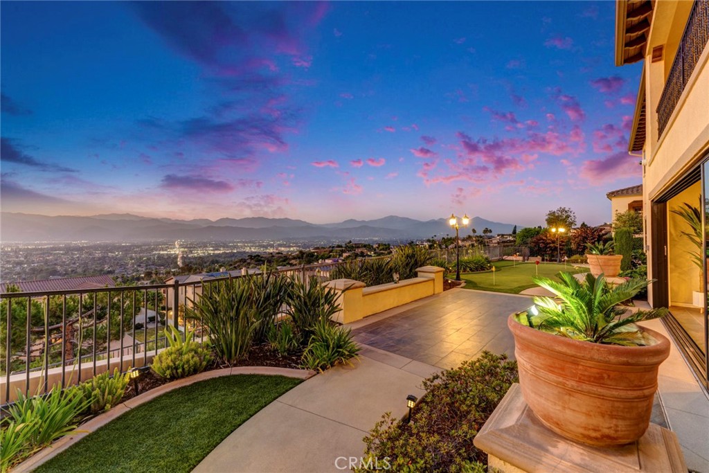 Stunning View Home in South Hills Estates – On the Market for the First Time!! This beautifully appointed, south-facing luxurious custom home is nestled on one of the most breathtaking city-view lots in prestigious South Hills Estates. Enjoy spectacular panoramic views of the San Gabriel Valley mountains and sparkling city lights from nearly most rooms. Extensively upgraded inside and out, this magnificent estate offers ultimate privacy with its own private automatic gate. Once inside, a landscape welcomes you to an expansive front porch featuring a charming fountain. Step into a entryway that opens to a soaring high-ceiling foyer and an elegant formal dining room. The spacious family room, complete with a cozy fireplace, A high stacking glass door connects the living space to a California room and a picture-perfect rear garden with 180-degree city views — complete with a mini golf area! There’s also a private deck off the Master Suite to fully enjoy the stunning vistas. The main-level Master Suite features a private retreat, dual sinks, and a convenient stacked washer/dryer. The home boasts 12-foot ceilings on the first floor and 9-foot ceilings upstairs. The gourmet kitchen features a large center island, and the countertops are custom-made with upgraded thickness, offering a more solid and textured feel compared to standard countertops, oversized walk-in pantry and complete with a custom full backsplash. Top-of-the-line Bosch stainless steel appliances, double oven, 5-burner cooktop, custom vent hood, and an 80” built-in Thermador refrigerator elevate this chef’s dream kitchen. Raised-panel custom cabinetry. A spacious breakfast nook opens to the great room, allowing you to take in panoramic mountain views while cooking or dining. Additional Luxury Features: • Crown molding • Upgraded wood flooring and premium carpet • Wood-frame windows • California Room with fireplace • 3-car tandem garage • Two powder rooms (main level and second floor) This exceptional residence offers five en-suite bedrooms, including two primary suites. Upstairs, discover three additional en-suites, one of which is a spectacular master suite with a large balcony that overlooks the shimmering cityscape. A generous loft on the second floor offers a versatile space that can serve as a sixth bedroom, home office, or entertainment area. NO HOA! Come visit us today and experience one of the finest locations with true panoramic views in South Hills Estates!