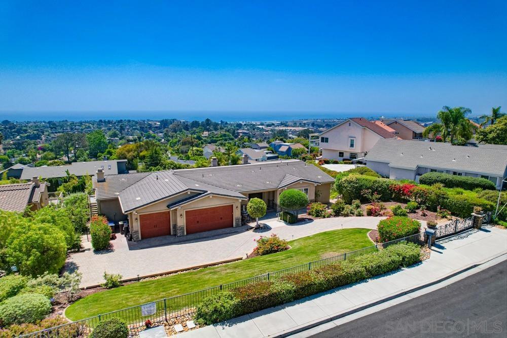 Spectacular 180-degree oceanfront views define this custom Tuscan-style estate perched on the bluff in Encinitas. Enjoy unobstructed coastline panoramas from nearly every room in this ~5,146 sq ft home featuring 4 bedrooms (plus office/optional 5th), 3 1/2 baths, and a spacious bonus room. Thoughtful details include travertine and hardwood flooring, coffered ceilings, oversized doors, and high-end GE Monogram appliances. French doors and multiple balconies create seamless indoor-outdoor living. Gated and private with a 3-car garage, lush landscaping, and timeless design—this is coastal luxury at its finest. No HOA, solar panels paid off!