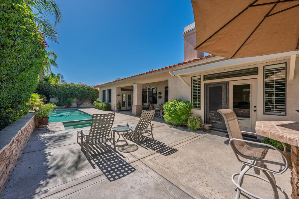 Resort-style living awaits in Rancho Mirage. This beautifully appointed five-bedroom home, including a detached one-bedroom casita, offers effortless indoor-outdoor living with a private pool, spa, and outdoor barbecue area. Located behind the gates of San Marino, residents enjoy pickleball and tennis courts, a community pool & spa and a serene desert setting just minutes from world-class golf, dining and the airport. Welcome to 65 San Marino Circle, an elegant desert retreat located within the private gates of San Marino, one of Rancho Mirage's most charming communities. Perfectly positioned in the heart of the Coachella Valley, this residence captures the essence of resort living with generous indoor-outdoor spaces, a detached guest casita, and a backdrop of palm-framed skies. Designed for both relaxation and entertaining, the home features 5 bedrooms (one is currently an office) and 4.5 baths, including a beautifully appointed one-bedroom, one-bath detached casitaa"ideal for guests or extended family. The main residence welcomes you with light-filled interiors, soaring ceilings, and open living and dining spaces that seamlessly flow toward the outdoors. A spacious kitchen anchors the home with granite countertops, a central island, ample cabinetry, and stainless-steel appliances, connecting easily to the breakfast bar and dining room with fireplace for casual or formal gatherings. The primary suite offers a serene escape with pool views, direct patio access, and a luxurious remodeled bath complete with dual vanities, walk-in shower and huge closet. Secondary bedrooms are generously sized, providing comfort and flexibility for family, guests, or creative spaces. Step outside and discover your private desert sanctuarya"a resort-style yard designed for year-round enjoyment. A sparkling pool & spa invite leisurely afternoons beneath the sun, while the built-in barbecue and shaded patio area create the perfect setting for alfresco entertaining. Mature landscaping and swaying palms frame the outdoor spaces, enhancing both privacy and natural beauty. Residents of San Marino enjoy a low-density, tranquil setting complemented by community amenities that include a large pool and spa, pickleball courts, and tennis courts. Located just minutes from world-class golf courses, fine dining, airport and the Eisenhower Medical Center, this home offers an exceptional blend of comfort & convenience.