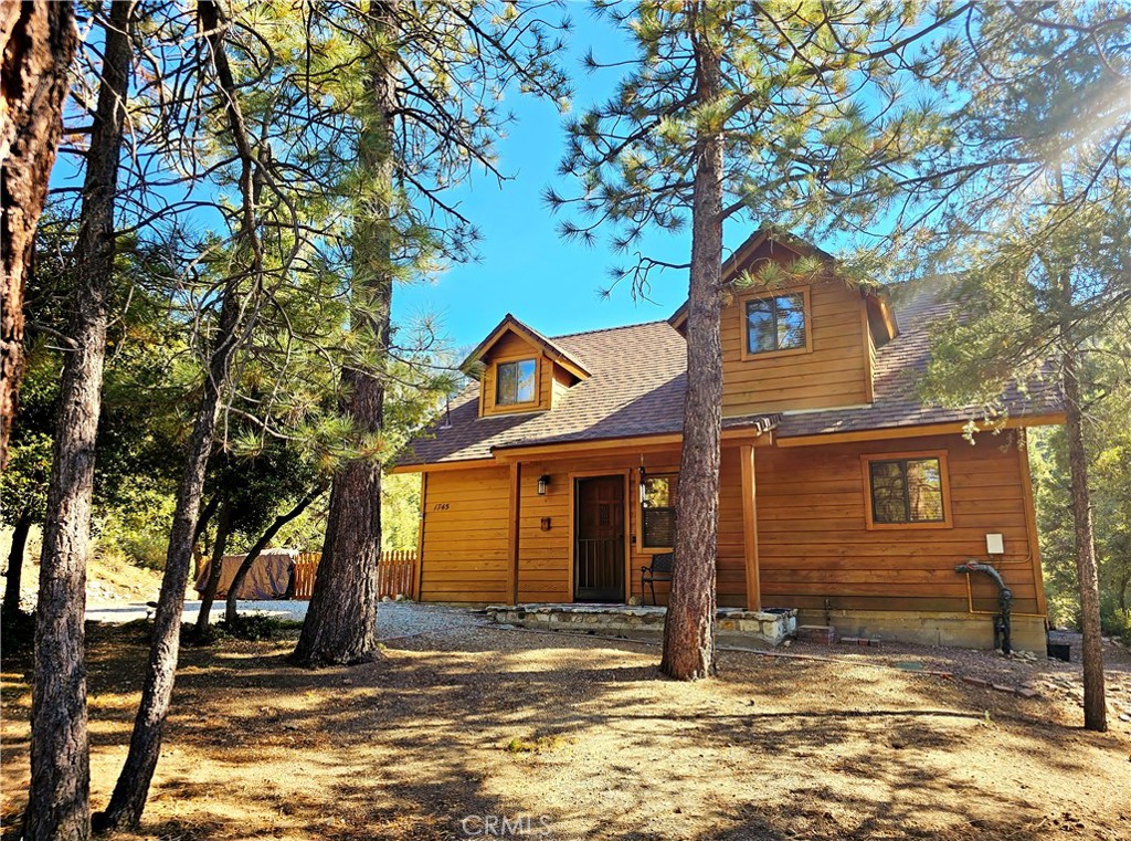 Welcome to your dream home nestled in the serene Pine Mountain Club - the property you’ve been looking for! The home is completely turnkey and everything is included, so there is nothing to do but move in. If you are looking for privacy, this property is at the top of the list. It features an open floor plan with a beautiful great room, knotty-pine-adorned vaulted ceilings and beams, and a massive calico stone fireplace. There are two double doors in the living room that open to a creatively shaped deck perched above the greenbelt, which boasts two areas with spectacular views of Mt. Pinos. The deck can also be accessed through the downstairs bedroom and a side gate. Enjoy outdoor relaxation with the included patio furniture and a huge umbrella. Entertain guests by the fire pit while grilling tasty steaks on the included propane BBQ. Two spacious bedrooms, one on each floor, each have their own full bath and a walk-in closet, plus there is a cozy loft with a sleeper sofa, perfect for a home office, overnight guests, or additional living space. Both baths have heat lamps for added comfort. Upstairs bath boasts a jacuzzi tub and a separate shower. And speaking of showers, the new 40-gallon water heater will ensure you have a reliable supply of hot water. For added security, the Ring alarm system and cameras stay with the property. The portable AC units, one upstairs and one down, are only 2 years old and will keep you cool during the warmer months. The Danby wine cooler and all appliances are included. The flooring – tiles and Berber carpeting – are in perfect shape throughout the home. In addition, the kitchen features a 3-filter reverse osmosis system, so there is no need to purchase bottled water. A partially fenced side yard with a flower bed is great for the avid gardener. The large front yard is like your own private forest. Pine Mountain Club is a 4-season community with peaceful sounds and sights of nature and clean air. Amenities include Olympic size pool, tennis courts, golf course, equestrian center, club house with a fine restaurant overlooking the golf course, and much more. With hiking, biking, concerts on the green, picnics in the park, Wine in the Pines, Lilac Festival, restaurants to please every palette and a village where you can shop 'til you drop, PMC is a dream! This home is perfect for those seeking privacy, comfort, convenience, and a touch of luxury in a truly peaceful mountain setting. Don't miss out on this incredible opportunity!
