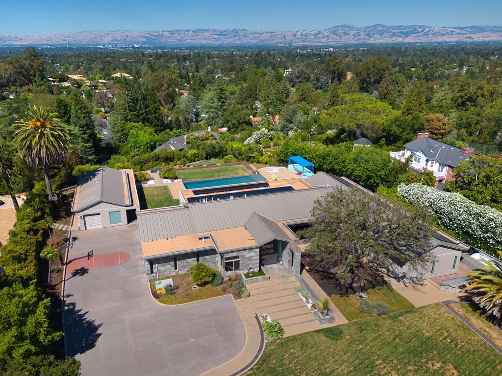 Sleek contemporary solar-powered one level luxurious home with exceptional panoramic views and state-of-the-art amenities on approximately 1.49 acres, office, study, massive kitchen family great room with polished concrete radiant heat floors, retractable glass walls opening to a vast heated loggia, infinity-edge pool/spa, outdoor kitchen, fire pit, putting green and a cabana with a steam shower. The open kitchen is equipped with high-end Gaggenau appliances and custom cabinetry. Primary suite with retractable glass on two sides, seamlessly opening without obstruction to a private terrace. Gated. 2bed/1bath guest house with full kitchen. Contemporary wine cellar. 3-car garage, detached 1-car garage. Entire home is ADA compatible. Excellent Los Gatos schools.