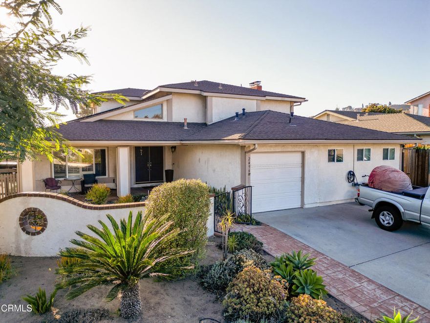 Welcome to this beautiful 4-bedroom, 3-bathroom home perfectly situated across from Charter Oak Park in one of Camarillo's most desirable neighborhoods. This spacious residence offers a warm and inviting floor plan, featuring a downstairs bedroom and bathroom ideal for guests or multi-generational living.  The elegant wrought-iron staircase leads to three additional bedrooms upstairs, including a generous primary suite complete with a cozy fireplace and ample closet space.  The park-like backyard is an entertainer's dream with a putting green, built-in BBQ, and plenty of space for relaxing or hosting gatherings under the Camarillo sunshine. An attached Junior ADU adds incredible flexibility perfect for extended family, guests, or potential rental income. The 3-car garage includes two stalls that have been thoughtfully converted to the ADU while maintaining functional parking and storage space.  Additional highlights include recently added solar panels for energy efficiency and a prime location directly across from the serene Charter Oak Park.  Enjoy the perfect blend of comfort, versatility, and outdoor living in this stunning Camarillo home!