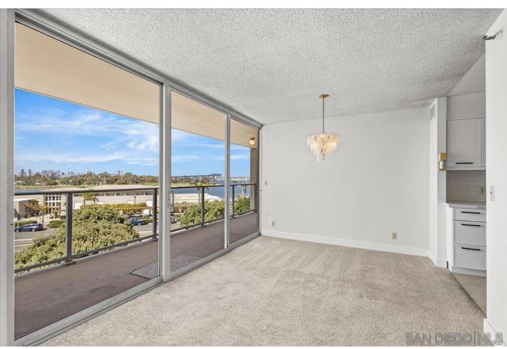 Enjoy nice cool summer days in this spacious, completely furnished two bedroom, two bath condo at luxurious Coronado Shores (furniture not shown in photos). Four oceanfront swimming pools, all with hot tubs, grills and tables to have a beachfront Bar BQ, seven tennis courts, two pickleball courts, large well equipped gym, private Beach Club, and spa- all included! A five minute (really) stroll to the beach puts you on the sand savoring the ocean breeze. The condo has a split bedroom layout- the private bedrooms are divided by the living areas. There is a big covered balcony that stays cool inviting you to have your favorite beverage and meal while watching the sailboats glide by, the Coronado Golf Course and the graceful arch of the Coronado Bridge. Beautiful by day and spectacular by night! All the rooms are spacious, there is in unit stack laundry, and much more all for less than the price of a 300 square foot hotel room. Available on July 8th til September 15th.