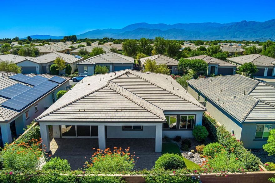 This beautifully appointed Liberty plan, located within the prestigious gated Trilogy Polo Club Shea Homes community, offers 2,367 square feet of refined single-level living with 3 bedrooms, 3 bathrooms, and a versatile den/office enhanced by elegant glass barn doors. The entry welcomes you through a custom front door to an inviting foyer with tile plank flooring and upgraded baseboards, leading into the expansive great room showcasing an open-concept design with a dual-sided, floor-to-ceiling tiled decorative fireplace and TV niche. The chef's kitchen is a true centerpiece, featuring quartz countertops, shaker cabinetry with brushed nickel hardware, a spacious prep island with seating and pendant lighting, subway tile backsplash, stainless steel appliances, built-in ovens, a 6-burner gas cook top with custom hood, and a generous pantry. Guest accommodations provide comfort and privacy, while the luxurious primary retreat shares the dual-sided fireplace and offers an en suite bath with quartz countertops, dual vanities, a beautifully tiled shower, and a walk-in closet complete with custom organizers. Outdoor living is equally impressive with a serene covered paver patio, professional landscaping with accent lighting, and ample space to relax or entertain. Additional highlights include a custom-designed garage with epoxy flooring, extensive built-in storage, and a separate golf cart garage. This home is a must-see for those seeking style, function, and sophistication in a premier desert lifestyle community.