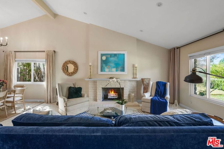 Canyon Calm, Modern Soul  A Viewridge Estates Sanctuary. Tucked within Topanga's beloved Viewridge Estates, where canyon breezes mingle with the scent of sage and sun-warmed earth, this exquisitely remodeled four-bedroom, three-bath residence captures the rare alchemy of natural serenity and refined modern living. Here, 2,100 square feet of open, light-filled design unfold across a generous corner lot of nearly 10,000 square feet, a home that feels both intimate and expansive, grounded and elevated, casual yet undeniably sophisticated.Inside, soaring vaulted ceilings and cool porcelain tile floors create a rhythm of space and stillness, while a sleek gas fireplace anchors the living room in quiet elegance. The newly reimagined kitchen is the heart of the home, a culinary atelier outfitted with professional-grade appliances, custom cabinetry, and soft LED lighting that glows like twilight through the wide sunlit windows. It's a space that inspires gatherings, laughter, and the slow ritual of morning coffee in the breakfast nook as the canyon wakes around you.Two luxurious primary suites, each with a serene, spa-like atmosphere and elegantly updated baths, offer ultimate flexibility for multigenerational living, remote work, or gracious guest stays. Every detail feels intentional, from the recessed lighting that traces the architectural lines to the thoughtful updates beneath the surface: copper plumbing, an upgraded electrical panel, and energy-efficient fixtures that blend sustainability with style.Beyond the glass doors, a vast backyard stretches beneath the Topanga sky, a sanctuary for entertaining under the stars, cultivating a garden, or swinging gently beneath the trees as the day drifts away. Fruit trees nod in the breeze, and there's ample room for play, for parking, for life, all framed by the soft silhouette of canyon ridges. The spacious carport can serve as a relaxing space, as well. With RV parking, a two-car carport, and EV charging already in place, the property balances rustic charm with modern readiness.Location, too, tells its own story: a mere ten minutes to the culture and convenience of Woodland Hills and Calabasas, twenty minutes to the wild beauty of Malibu's coast, and steps from the hiking and biking trails that weave through the Santa Monica Mountains. It's a home that offers the best of both worlds, where nature hums just beyond your door, yet every comfort and connection lies within easy reach.In Viewridge Estates, life moves at a gentler tempo. Mornings begin with golden light spilling through vaulted spaces, afternoons unfold beneath oak-dappled shade, and evenings close with the hush of crickets and the scent of jasmine. This is more than a home, it's a modern canyon refuge, designed for those who seek calm without compromise, beauty without pretense, and a seamless harmony between the soulful and the contemporary.