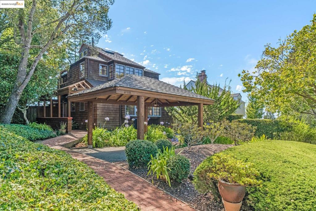 A Sea Ranch-inspired retreat in the Berkeley Hills, this home blends timeless character, thoughtful design, and a peaceful garden setting. The main level offers a formal dining room with garden views, a cheerful sunroom, two bedrooms, a full bath, and laundry. Upstairs, a spacious living room with vaulted beam ceilings and bay views opens to a private primary suite and a versatile loft—perfect for a home office, library, or retreat. Mature landscaping and blooming perennials frame outdoor spaces ideal for dining, relaxing, or gardening. Though private and peaceful, the home is minutes from Solano Avenue and North Shattuck shops and dining, UC Berkeley, Tilden Park, and commute routes to Walnut Creek and San Francisco. A rare balance of tranquility and accessibility in one of North Berkeley’s most desirable neighborhoods.