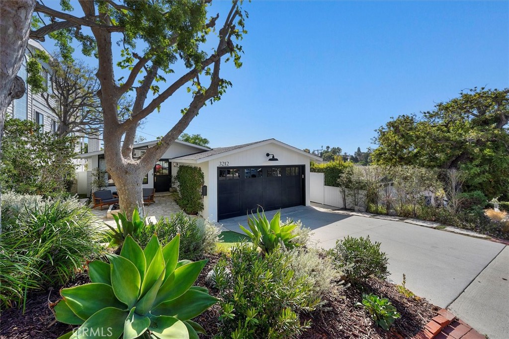 This beautifully remodeled and updated 3-bedroom, 2-bathroom home offers the perfect blend of modern design and coastal charm. Guests are welcomed by an entertainer’s patio with a custom fire feature, leading to a striking Dutch door with brass hardware. Inside, the great room showcases an open-concept layout with a modern kitchen, oversized island, and spacious living area highlighted by vaulted ceilings and white bead board finishes. A warm gas log fireplace with custom, distressed wood mantel and built-in Sonos surround sound system complete the elegant atmosphere. Recent upgrades include new electrical, plumbing and air conditioning, complemented by an Ecobee smart thermostat for efficient climate control. Throughout the home, Restoration Hardware lighting and fixtures pair seamlessly with wide-plank French white oak flooring. The chef’s kitchen is outfitted with Thermador appliances, custom awning windows, and a Fleetwood sliding glass door that extends to a large, attached mahogany deck, providing additional space for entertaining. Beyond, the expansive backyard is finished with turf for easy maintenance, complemented by extensive garden space and plenty of room for recreation. Each of the three bedrooms features vaulted ceilings, custom Smith & Noble window coverings and thoughtfully designed closets. Both bathrooms have been recently upgraded and include marble countertops, custom cabinetry and frameless shower doors. The finished garage includes drywall, industrial epoxy flooring, built-in laundry with storage, and a 220-volt outlet for electric vehicle charging. Ideally located near downtown Manhattan Beach, the Greenbelt, and just minutes from the sand and surf, this home embodies refined coastal living at its best. Architectural plans for remodel/addition available for review.