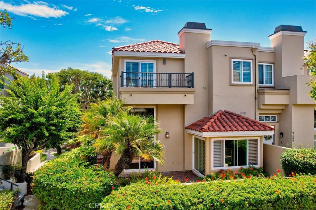 Enter At Your Own Risk!! You may Never want to leave the Serenity and Peace of this beautiful guard gated community, Seacliff On The Greens, with it's large majestic trees, meticulously manicured lawns and colorful flowers lining Cherryhill Drive. Feel right at home walking safely throughout this quiet yet robust enclave situated just 1/4 mile from the Beach. Enjoy this well maintained Plan 500 end unit with all the builder upgrades boasting Surf City Living!! The 3 bedroom 3 bath townhome enjoy's real hardwood flooring, a built in Den/Library w/fireplace and wet bar with rows of shelving to accommodate even the most dedicated Work From Home enthusiast! and an upstairs loft/4th bedroom. The community offers multiple pools and spas, direct walking access to the exclusive Huntington Golf and Tennis Club, a short walk to the beach, to award winning schools (HBHS and Seacliff Elementary), a robust downtown and the amazing Sea Cliff Shopping Center (LA Fitness, Albertson's, Starbuck's, Multiple banks and dining options). Added amenities include an upgraded kitchen with beautiful granite counters and SS appliances, Central AC, a 2 car attached garage, newer dual pane windows with classy shutters and soft drapery, a wide open interior, large primary bedroom w/fireplace and vaulted ceilings w/large walk-in closet w/laundry chute to the indoor laundry room. Live in and bask in the near perfect year round weather on the private first floor patio and dual 2nd floor view decks. **Come see it, Love it and Make it your own!!***