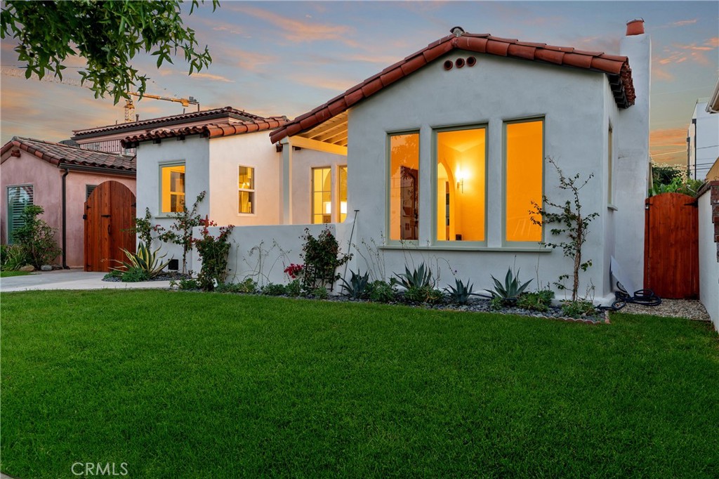 Spanish Revival Beauty on Ivy Street
Welcome to 3159 Ivy Street, a timeless 1929 Spanish Revival rebuilt and reimagined for modern living. Nestled on a quiet, tree-lined street, this single-level residence features 3 bedrooms, 2 baths, a den, and a detached studio—blending authentic architectural character with thoughtful upgrades.
From the moment you arrive, the arched patio and classic clay-tiled roof set the tone. Inside, natural light floods warm hardwood floors, graceful archways, and expansive windows that frame the lush front yard. The open floor plan connects the living room, dining area, and all-new kitchen—perfect for both cozy evenings and lively gatherings.
The kitchen marries style and function with Spanish arches, custom tilework, Calacatta Eternal quartz countertops, generous storage, KitchenAid appliances, under-cabinet lighting, and a powerful ceiling-mounted hood, keeping sightlines open for entertaining.
Three spacious bedrooms offer comfort and privacy, complemented by a versatile den that is ideal for a home office. The oversized primary suite offers an ensuite bathroom, dual closets, and direct access to the backyard and studio. Bathrooms are designed with a distinctive flair: the hall bath channels the home’s 1929 heritage with a romantic tiled arch over a six-foot soaking tub for two, while the primary bath showcases a spa-like retreat with a massive walk-in rain shower, a freestanding tub, and an oak double vanity.
Step outside onto exotic Camaru Brazilian hardwood stairs and into your private backyard oasis. Perfect for entertaining, gardening, or relaxing under California skies, the outdoor space is enhanced by a finished two-car garage/studio with French doors that extend the indoor-outdoor flow.
Set on a 5,398 sq. ft. lot, this home offers tranquility and versatility while being just moments from the Helms Bakery District, Culver City dining, Shay Hotel, and the Ivy Metro Station. Major tech and entertainment employers—including Apple, Amazon, Warner Discovery, and Sony Studios—are right around the corner.
More than a home, 3159 Ivy Street is a piece of Los Angeles history infused with modern comfort. Don’t miss your chance to own this Spanish treasure in one of the city’s most dynamic neighborhoods.
3159 Ivy Street—where your next chapter begins.
