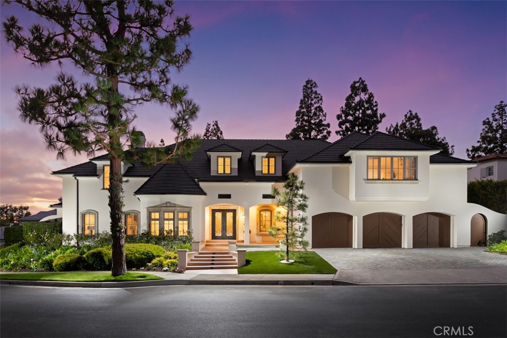 Situated within the gates of Newport Beach’s exclusive Big Canyon Country Club, this recently reimagined estate rests on a coveted peninsula lot, delivering unparalleled privacy and serenity. Spanning approximately 8,210 square feet, the residence blends timeless sophistication with modern livability across a thoughtfully designed floor plan. The main-level primary suite offers a luxurious escape with generous proportions, a stately fireplace, and a spa-inspired ensuite. Five bedrooms and five and a half baths ensure comfort and privacy for family and guests alike. At the heart of the home lies a chef’s kitchen featuring dual islands, top-tier appliances, and a spacious walk-in pantry—perfect for culinary pursuits and entertaining. The adjoining great room showcases wide open spaces and direct access to the backyard , creating an inviting environment for relaxation and gatherings. The lush, landscaped grounds serve as an outdoor sanctuary with a sparkling pool, spa, built-in BBQ, and multiple dining and entertaining pavilions ideal for enjoying Southern California’s endless sunshine. Just moments away from world-class shopping, fine dining, pristine beaches, and championship golf courses, this exceptional estate combines superior craftsmanship, elegant design, and an unbeatable location to deliver the ultimate in coastal luxury living.