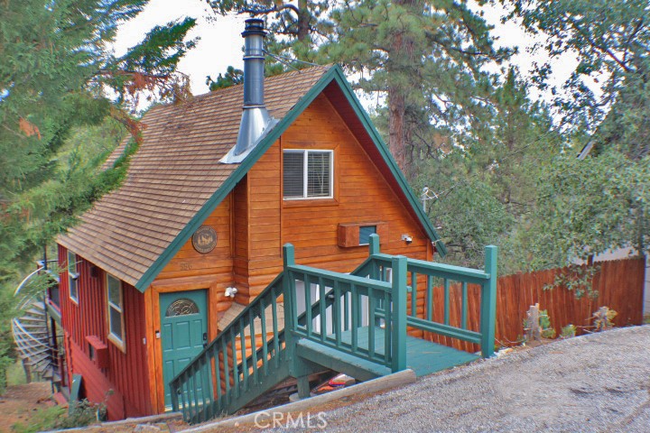 What a wonderful classic cabin on almost a half acre lot! Cute log style exterior and located on a quiet street in a lovely location in Moonridge. Beautifully updated home with vinyl plank flooring, kitchen with granite counters, newer cabinets, stainless appliances ,and open great room with cozy fireplace! Downstairs enjoy a stylish fully updated bathroom, laundry room and upstairs the coziest bedrooms feature cathedral knotty pine ceilings. But wait there is more! Outside features are awesome with upper trek style deck featuring lovely outdoor furniture, gazebo with party lights, BBQ and dining all overlooking your own enchanted forest! A spiral staircase leads to an equally amazing lower deck with gorgeous outdoor spa, and cozy furnishings. This is the sweet cabin you have been looking for and it's also a successful vacation rental!