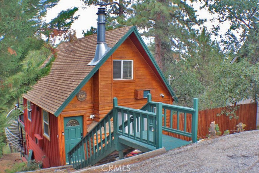 What a wonderful classic cabin on almost a half acre lot! Cute log style exterior and located on a quiet street in a lovely location in Moonridge. Beautifully updated home with vinyl plank flooring, kitchen with granite counters, newer cabinets, stainless appliances ,and open great room with cozy fireplace! Downstairs enjoy a stylish fully updated bathroom, laundry room and upstairs the coziest bedrooms feature cathedral knotty pine ceilings. But wait there is more! Outside features are awesome with upper trek style deck featuring lovely outdoor furniture, gazebo with party lights, BBQ and dining all overlooking your own enchanted forest! A spiral staircase leads to an equally amazing lower deck with gorgeous outdoor spa, and cozy furnishings. This is the sweet cabin you have been looking for and it's also a successful vacation rental!