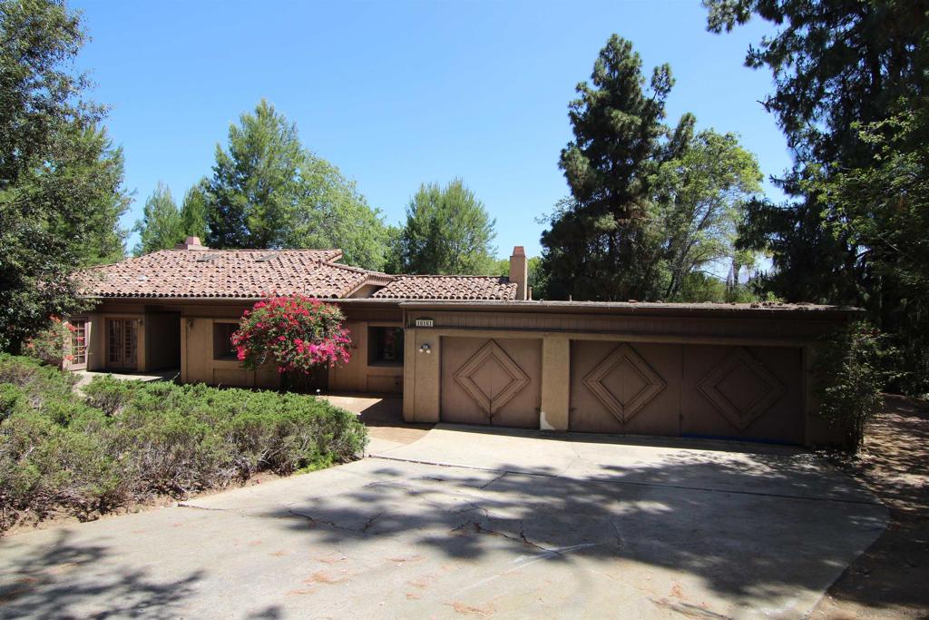 Wow! First time ever on the market! Perfect for an end user looking for a sprawling ranch style estate with endless potential that just needs a hug! Discover a unique opportunity to create your own dream home in the highly sought after Poway neighborhood of Ladera Piedra (no HOA or Mello-Roos). An expansive 4-bedroom, 2.5-bath single-story home, offering over 2,800 square feet of living space and situated at the end of a quiet Cul-De-Sac on a generous flat and fully usable half-acre lot. This well-laid-out property features a bright and open floor plan, including multiple living areas with wood burning fireplaces, chefs delight kitchen with a plethora of cabinets and counter space, and a formal dining area perfect for entertaining or family gatherings. The primary bedroom includes an en-suite bathroom and lots of closet space, while the three additional bedrooms offer flexibility for guests, hobbies or a home office. Outside, enjoy the oversized 3-car garage and a spacious level backyard with plenty of room for a pool, garden, RV, boat or other weekend motorized toys. While the home is structurally solid, it’s ready for cosmetic updates—bring your vision and add value with new flooring, paint, and modern finishes. Located in a quiet, established neighborhood with easy access to Poway Unified Schools, shopping, and major highways, you won't want to miss this rare chance to own a large, single-level home with plenty of room to grow. Wow!