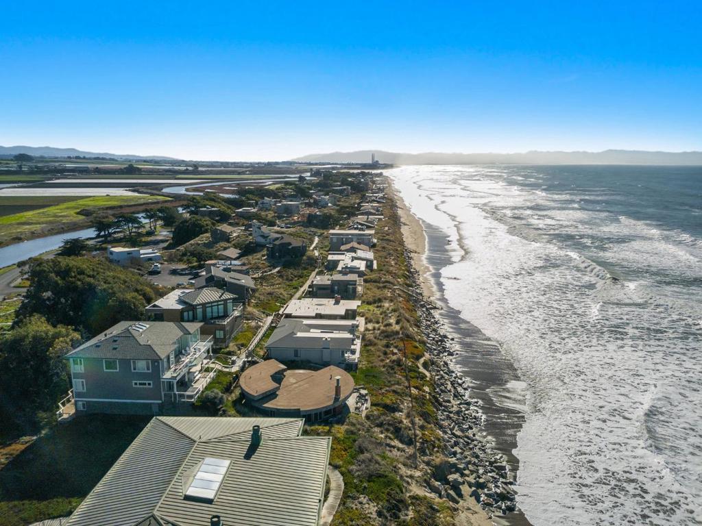 Introducing a one-of-a-kind Ocean Front property, exuding the distinctive charm of Pajaro Dunes. This exceptional round home is perched perfectly on the edge of California paradise, providing a mesmerizing 180-degree view of the Monterey Bay Ocean. The expansive wall of windows not only showcases the home's focal point but also invites you to move right in and relish all that this gated community has to offer. Featuring 4 bedrooms and 3 bathrooms, this unique residence spans just under 2,000 square feet, nestled on a spacious 9,000+ square feet lot. Whether you're in search of an investment property or a place to call your own, 60 Avocet promises to fulfill your desires. Immerse yourself in the tranquility and beauty of coastal living, where each moment is accompanied by the soothing sounds of the ocean waves and the breathtaking scenery of the Monterey Bay. This is not just a home; it's a lifestyle awaiting your presence.