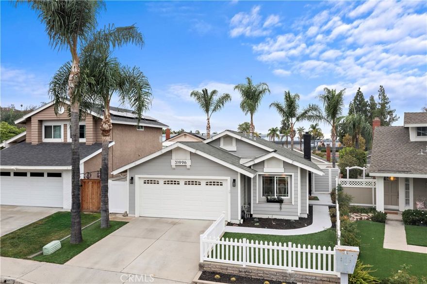 Ideally located on a peaceful side street cul-de-sac in the heart of Robinson Ranch surrounded by beautiful mountains, this updated single-level stunner is sure to impress! Upon arrival, high-pride-of-ownership is apparent with fresh improvements including newer exterior paint, light fixtures, and stylish landscaping. A white picket fence frames in the low-maintenance and useful front turf yard - a great outdoor space! An entry Dutch door welcomes you inside the large living room with a cozy gas fireplace, ascending ceiling plate with overhead fan and wired surround sound. Recently painted inside, the light and bright interior contrasts the dark hardwood flooring throughout. Just off the living room, the updated kitchen offers stainless appliances (newer range), new quartz counter tops, a new sink and faucet, a centered island, formal dining, clever bar-top seating, wainscoting, and ample Eastern-seaboard-style cabinetry for abundant storage. Large picture windows let natural light into the space and glass slider doors access the rear and side patios with an in-line gas fire pit. Very private outside and rare to come by! The family room and open kitchen create an inviting space for relaxing and entertaining. Beyond the living areas, three generous bedrooms (one currently a nursery, one used as an office with bay window and vaulted ceilings) and two nicely-remodeled bathrooms all provide comfortable, turn-key living. The primary offers his & hers mirrored closets, wainscoting, and spa-like bathroom with new vanity, dual sinks, fixtures, counter top, shower enclosure, tile, and mirror. The full guest bathroom has also been highly upgraded in similar fashion and offers a tub. Other newer improvements and values: recessed lighting throughout, light fixtures, ceiling fans, interior/exterior paint, crown molding, a finished garage with MyQ smart garage door system, additional storage cabinets, epoxied floors, washer/dryer, water heater, privacy side gate, and routinely maintained HVAC system. Just a short walk to Blue Ribbon Robinson Ranch Elementary, amazing neighborhood parks, community pool and amenities, and close to shops, dining, and entertainment, this home offers turn-key convenience and a fun lifestyle beyond.