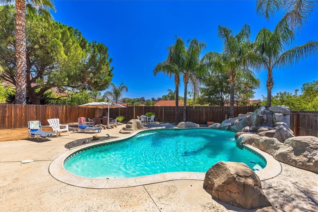 Welcome to 142 N. Terra Cotta, one of only a handful of PRIVATE POOL homes currently on the market on the north side of Lake Elsinore! This cute single story offers an open floor plan with 3 bedrooms, 2 bathrooms, and a 2 car garage. Interior features include neutral paint; tile and faux-wood flooring; comfortable living spaces; upgraded kitchen with stainless steel appliances; ceiling fans throughout; and a cozy, brick fireplace in the living room. The outside offers mature and established, easy-care landscaping, a covered patio beyond the 2 sliders ~~ one from the family room and the other from the primary bedroom ~~ and of course, the STUNNING POOL WITH WATERFALL FEATURE! Plus, there's several sitting areas and extra space at the far end of the lot for a play set or your favorite vegetable or flower garden. Imagine all the fun family gatherings that could be hosted from this entertainer's backyard! Memories will definitely be made here! But, wait....there's more! A solar panel system with Good Leap was installed in April 2024 and now the house and pool are powered by the strong So. California sunshine. This is a cost-saving feature for the lucky homeowner! Well-known for low taxes and no HOA fees makes 142 N. Terra Cotta a perfect selection for first time buyers or folks scaling down from a larger home. Located close to schools and shopping, and only a short distance from the 15 freeway, Ortega Highway, Lake Elsinore, and Storm Stadium. Additionally, all the Temecula amenities are close enough to enjoy but far enough away to not be bothered by the city's hustle and bustle...Old Town, Pechanga Casino, the Promenade Mall, and the valley's world-renowned wine country. Don't miss out...call for an appointment TODAY!