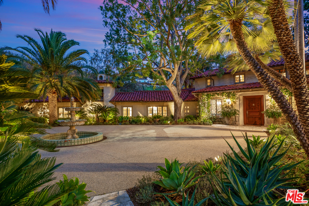 Of the 48 properties located directly on the Bel Air CC golf course, this is the 2nd largest property of them all. Located behind gates on a very prime cul-de-sac in the most prime section of Bel Air, one of the largest flat properties in Bel Air that directly adjoins the Bel Air Country Club Golf Course. A long private driveway leads to a huge circular motor court and a stunning Mediterranean villa, designed by Gerald Colcord. Situated on 2.5 acres of world class gardens, amazing lawns, resort-like pool, meandering paths, and gorgeous towering trees, all overlooking stunning golf course and city views. Beautiful living room with beamed ceilings, stone fireplace, large formal dining room, incredibly charming library with fireplace, gourmet kitchen with center island, separate breakfast room. Upstairs features an amazing master suite with soaring ceilings, and 2 separate guest suites, beautiful separate office/guest house, staff quarters, downstairs guest room, and much more.