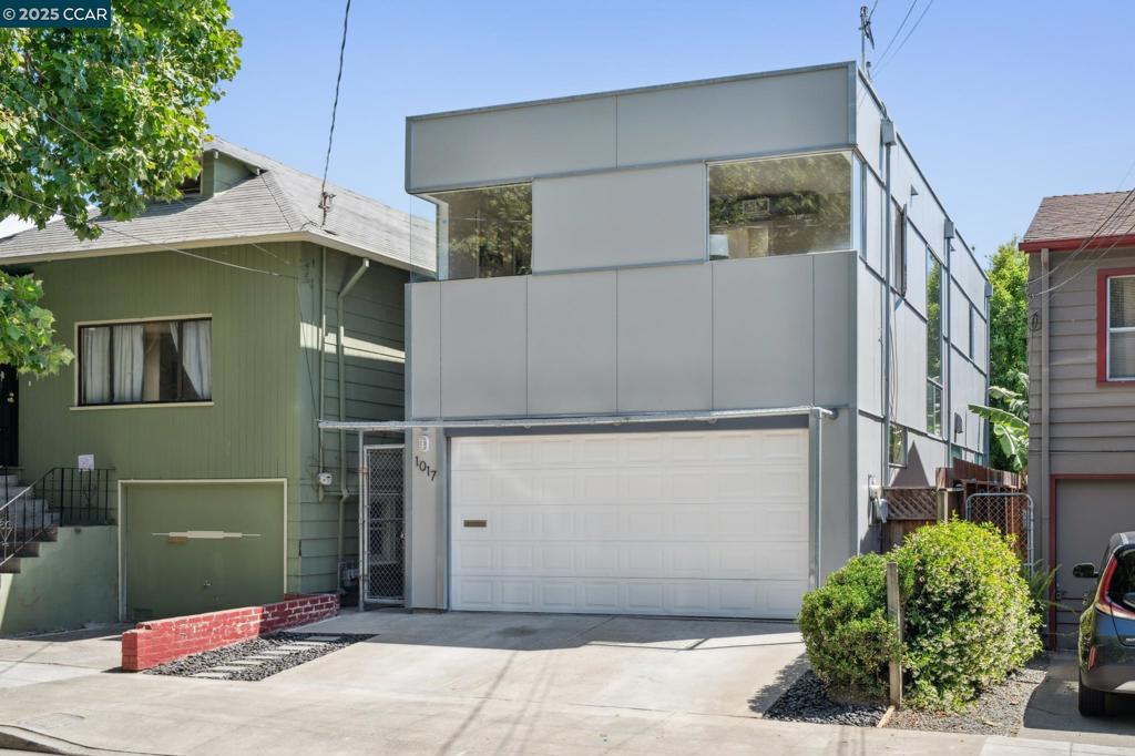 Hidden Gem on the Emeryville/Oakland Border. Built in 2003, this contemporary 1,515 sq. ft. home offers modern urban living at its best. Step inside to discover an open layout on the main level-perfect for entertaining. The living space flows seamlessly through sliding glass doors into a private garden oasis. The chef’s kitchen features a refreshed look with quartz countertops, new appliances, a new sink and faucet, and freshly painted cabinets. A peninsula adds extra seating. With soaring 10-ft ceilings, large windows, and an industrial-modern vibe, the home is flooded with warm natural light. Upstairs, you’ll find two spacious bedrooms, each with en-suite bathrooms, updated light fixtures, and ceiling fans. Primary suite boasts a walk-in closet. A convenient half-bath powder room on the first floor, and a full-size laundry with stackable washer/dryer is on the second. Fresh interior and exterior paint, 2-car garage with automatic opener and direct access into the home, plus exterior built-in trellises ready for your favorite climbing plants. Truly a Walker’s Paradise. Enjoy car-free living, walk and bike scores of 92 and 97! Steps from the Emeryville Greenway, Bay Street shops, restaurants, parks, and quick freeway access, plus free Emery Go-Round shuttle to BART. Welcome Home!