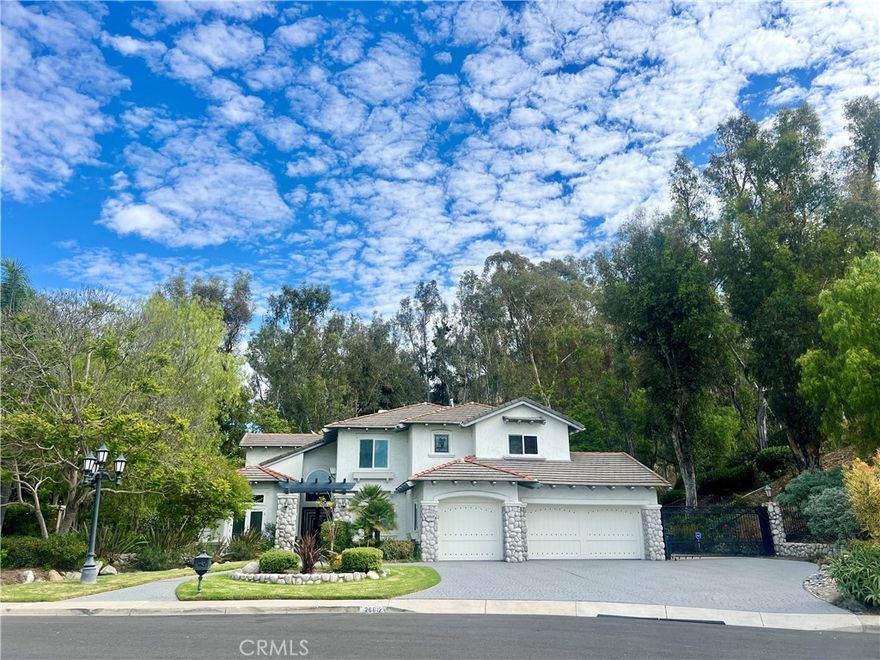 Fabulous 4 bedroom 3 bath home on nearly 1 acre offered for lease in the Capistrano Royale neighborhood of San Juan Capistrano. 3 car garage with Epoxy flooring and large driveway, plus gated larger vehicle/RV or boat parking. Impressive custom double door entry hall with romantic curved staircase. Beautiful front facing formal living room with french doors. Formal dining room with sparkling lighting and french doors leading to backyard. Gorgeous remodeled kitchen with beautiful upgraded cabinetry, 6 burner Wolf range and griddle with Wolf exhaust hood, SubZero refrigerator and SubZero Wine Refrigerator, walk-in pantry, dramatic waterfall center island, sunny breakfast nook, platter sized sink with backyard view, Bosch dishwasher, microwave, and beautiful fixtures and finishes. Family Room with Remote controlled Fireplace is open to the kitchen with french doors leading to backyard lanai. Primary bedroom with backyard views and sitting area retreat. Sumptuous primary bath has two sinks, sit down vanity area, separate glass enclosed shower and big bathtub. Great walk in closet with custom built-ins. Two additional bedrooms with dual vanity bath, plus large bonus room with sink and space for mini-fridge. Downstairs office or bedroom with built in shelving and desk with attached bath. Resort like backyard with river rock pool and huge inspiring trees make it feel like a forested private park. Charming white gazebo serves as a delightful refuge for morning coffee or tea or afternoon reading. Pergola breezeway along the back of the home provides spaces for entertaining and enjoying California's indoor outdoor lifestyle. Community center with pool, spa, bbq, seating, clubhouse, tennis/ pickleball court, lawn, and sand volleyball court surrounded by historic California Sycamore trees.