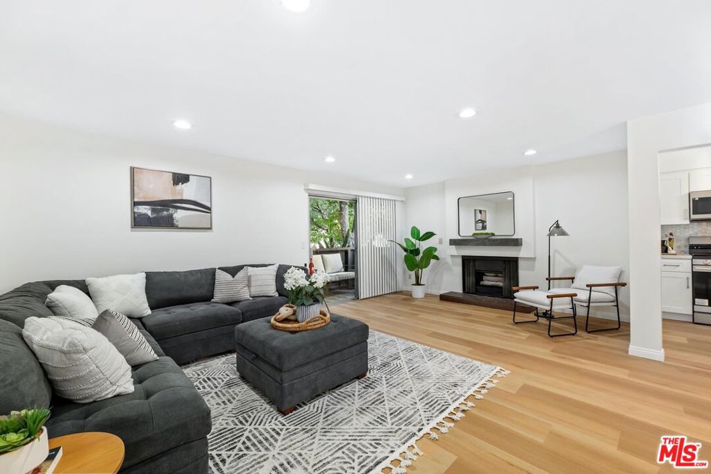 Beautifully renovated and move-in ready, this ground-floor condo at The Colonies offers a fresh take on comfortable living in the heart of Van Nuys. Featuring 2 spacious bedrooms and 2 full bathrooms across 1,113 sq ft, the home has been thoughtfully updated with modern finishes throughout. The bright and open living area includes a decorative fireplace and sliding doors that open to a private patio, perfect for indoor-outdoor relaxation. The brand-new kitchen shines with updated cabinetry, countertops, and appliances, while both bathrooms have been stylishly refreshed with contemporary fixtures. The primary suite boasts a walk-in closet and an en-suite bath. Additional highlights include in-unit laundry, central air and heat, and new flooring throughout.Residents enjoy a secure gated community with resort-style amenities, including a pool, spa, clubhouse, and beautifully landscaped grounds. Two assigned covered parking spaces are included. Conveniently located between Kester Ave and Noble Ave, with quick access to shopping, dining, and the 405 freeway, this home combines style, comfort, and convenience in one inviting package.