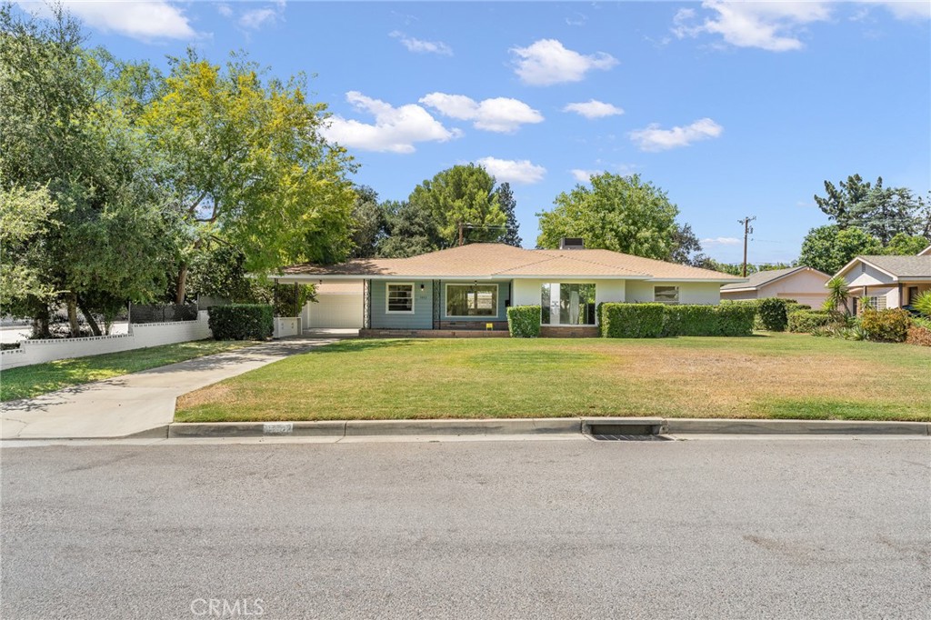 Welcome Home to this TURN-KEY property in the charming pocket neighborhood of BLAIR PARK. Step back in time to the sweetness of yesteryear with tree-lined streets and longtime neighbors. Pride of ownership shows at every address. Boasting 1725 sq ft of living space, this 3-bedroom 1.5 bath home is just oozing with charm. Picture and bay windows allow fresh light to wash the rooms with sunlight, and a peek at the distant mountain views. Vintage built-ins and room dividers add charm. You will love gathering friends in the darling kitchen featuring cheery original tile counters, real wood cabinetry, and a brand new gas range. The fun banquet dining area is like having your very own diner or coffee shop. Everything in this home is spotless and move-in ready. ALL NEW LUXURY VINYL PLANK FLOORING THROUGHOUT. FRESH INTERIOR AND EXTERIOR PAINT. NECESSARY MAINTENANCE ITEMS HAVE BEEN COMPLETED! EXTRA BONUS: a WHOLE HOUSE GENERATOR so power outages won’t ruin your day. Three good-sized bedrooms, Living Room, Dining room, Den/office space, and two vintage bathrooms complete the space. Now, let’s talk about the yard! EXPANSIVE 18,240 SQ FT LOT enjoys alley access too. The main yard space is welcoming with mature landscaping, a nice, covered patio area for entertaining, and plenty of space for gardening. Beyond the fence, explore the “back 40.” If you are thinking about rental income, this enormous space is prime for you to add an ADU. Or if ample parking for cars, RVs, or boats is your priority, this lot can accommodate with ease. Location of this property is super commuter friendly and is also near golf courses, the university, and local hospitals too. Don’t delay! See this one today.