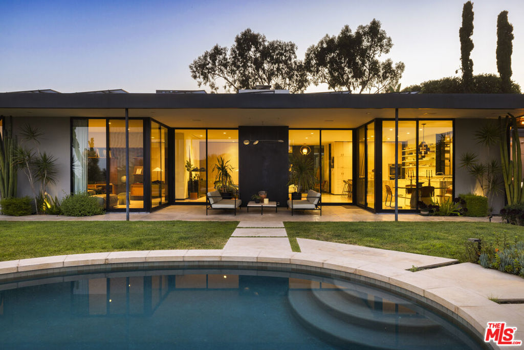 The Maurice Seiderman House, 1955. In 1955, Maurice Seiderman, the legendary Hollywood makeup artist whom Orson Welles called "the greatest make-up man in the world," and who was responsible for Citizen Kane, A Touch of Evil, and Jane Eyre, among other films, commissioned architect Clyde Grimes, to design a home for him on a rare, large, flat promontory in the Hollywood Hills with unobstructed views sweeping from downtown to the ocean. Grimes was born in Los Angeles in 1924, was a member of the legendary Tuskegee Airmen during the Second World War, then earned his architectural degree at U.C. Berkeley. Upon graduation, he apprenticed under the legendary Paul Williams before opening his own practice. He capped off his career by being appointed by Governor Jerry Brown as the Official State Architect of California. Grimes' modernist tour de force on Deronda Drive remained virtually untouched and original until a thorough and sensitive restoration by the celebrated design firm Commune/Pam Shamshiri AD 100 and architect Barbara Bestor, with landscaping by Elysian Landscapes. The result is a visual triumph, seamlessly blending modern conveniences into the renewed soul of a true mid-century masterpiece. To add to its legacy, the property was fused with the adjoining historic Aldous Huxley estate, creating one of the largest flat plateaus anywhere in the Hollywood Hills, with an unheard-of approximately one-acre mostly flat, level pad. This rare, vast land presents the opportunity to build additional outbuildings, tennis and pickleball courts, a compound, or several distinct additional homes, as the estate comprises three separate APN parcels with separate entrances on two different streets. Privacy is paramount for this property. The entry is gated, and the home is shielded from the street by an unassuming facade wall, while the vast flat grounds are raised high above the street, preventing line-of-sight viewing into the yard. Furthermore, the views overlook hillsides and the city to the ocean, rather than facing other homes and roofs at eye level. Once inside the gate, a courtyard entry opens into the home, revealing soaring ceilings and vast rooms that flow to the covered patios, a large, flat, and lushly landscaped yard, the stunning saltwater pool, and the breathtaking city-to-ocean views beyond. The sumptuous primary suite also opens to the views and features its own private patio, a luxurious boutique-like dressing room, and an elegant marble bath. Two other en-suite bedrooms complement this home. There is also a large media room, a fireplace in the living room, a dining room that is open to the views, and a covered outdoor dining room with a kitchen, BBQ, and refrigerator. The open main kitchen features a dining island, Sub-Zero and Miele appliances, and generous storage. Other features include full Crestron and Nest automation and security systems, an infrared sauna, a secure two-car garage, additional driveway parking, and almost unlimited parking on the extensive grounds. The home is infused with light from the floor-to-ceiling Fleetwood doors and countless skylights throughout. This home is a rare opportunity to live in a modernist work of structural art on a private and incredibly large parcel in the Hollywood Hills, with land to create your dream estate while being close to all the fine restaurants, shops, and attractions the city offers.
