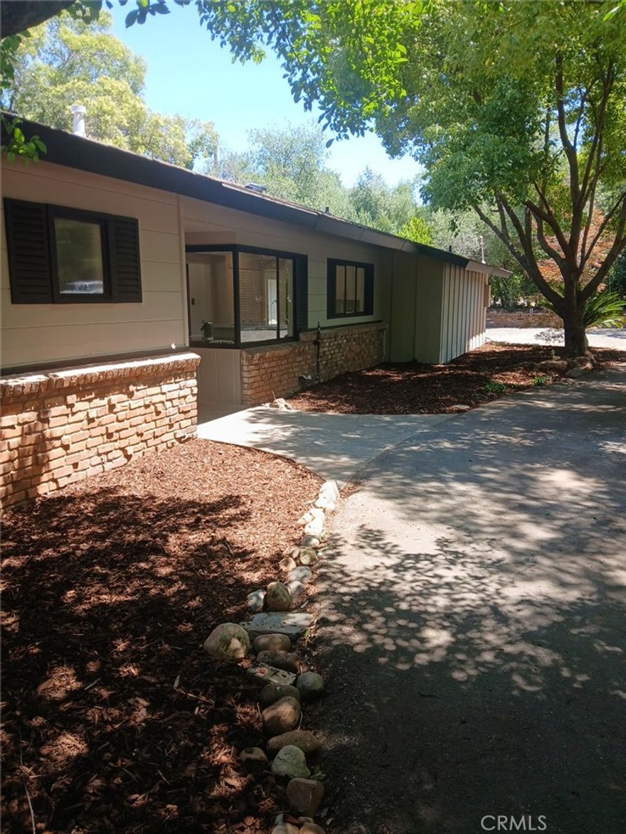 Extensively remodeled and move-in ready, this beautifully updated home is located in one of the most sought-after areas of Oroville’s East Foothills. Set on a level, usable .34-acre lot, it offers peaceful privacy while remaining just minutes to shopping, schools, Hwy 70 access, and multiple nearby boat launches for Lake Oroville adventures!



Boaters will love the location: only approx. 2 miles to Loafer Creek Boat Ramp, 3.5 miles to Bidwell Canyon Marina with rentals and launch facilities, and about 4 miles to Spillway Boat Ramp—ideal for year-round recreation. And yes—the lake is full and ready for summer fun!



Step inside and enjoy fresh paint, waterproof plank flooring throughout, recessed lighting, and all-new fixtures. The stunning kitchen features Carrera quartz counters, white oak open shelving, stainless steel appliances, soft-close hardware, and a large pantry with extra cabinetry and butcher block counter space. The breakfast nook is light and bright with large corner picture windows and a designer fandelier.



The living/dining room is rich with character, showcasing open-beam redwood ceilings, shiplap, a redwood beam mantle, earth-tone slate hearth, and built-in shelving. The hallway bath includes a new vanity, eco flush toilet, black slate tile flooring, and porcelain tub/shower surround.



The spacious primary suite boasts double French doors, large picture windows, a makeup counter, new vanity, slate flooring, eco flush toilet, and a porcelain walk-in shower with floor-to-ceiling tile. All interior doors and casing are new solid-core upgrades, with maple cabinetry and dovetail drawers throughout.



Enjoy outdoor living with a 10x50 cement/slate patio, 8x14 gazebo with its own cement pad, and a fenced, level backyard featuring mature landscaping and fruit trees: cherry plum in front; in back—pink lady apple, Rainier cherry, orange, two peach trees, fig, and three large banana trees, plus a grapevine. A 15x6 concrete pad with water awaits your garden shed or hobby space.



Other highlights: single-car garage with automatic opener, attached shop, new 40-gallon water heater, red cedar batten board siding with brick accents, concrete and brick planters, side yard access from east and south sides, circle driveway, and paved parking for up to 12 vehicles.